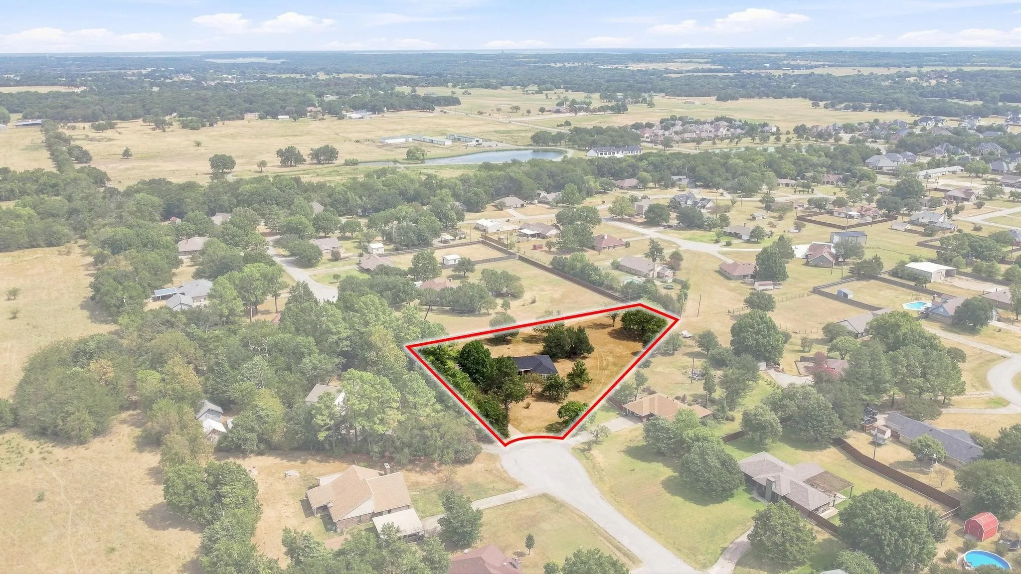 Expansive lot with mature trees and a residential structure