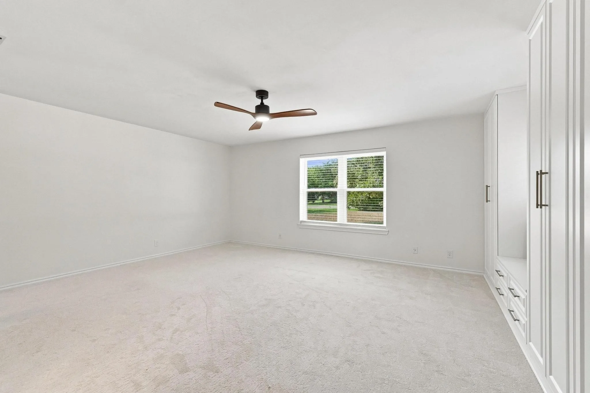 Large master primary suite with enough room to make a cozy sitting area in addition to one entire custom wall closet system offering ample storage.