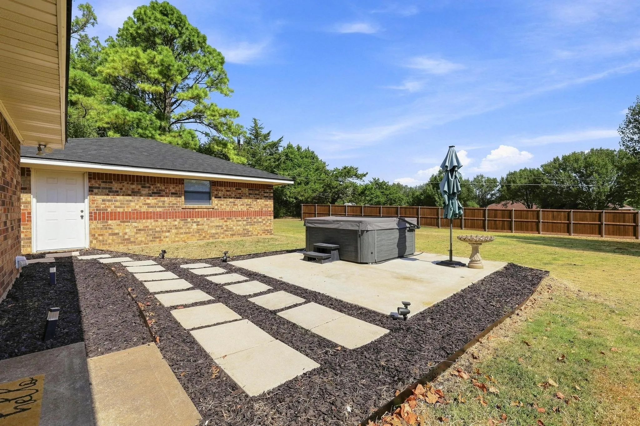 Nice landscaped walkway to detached garage and to the hot tub