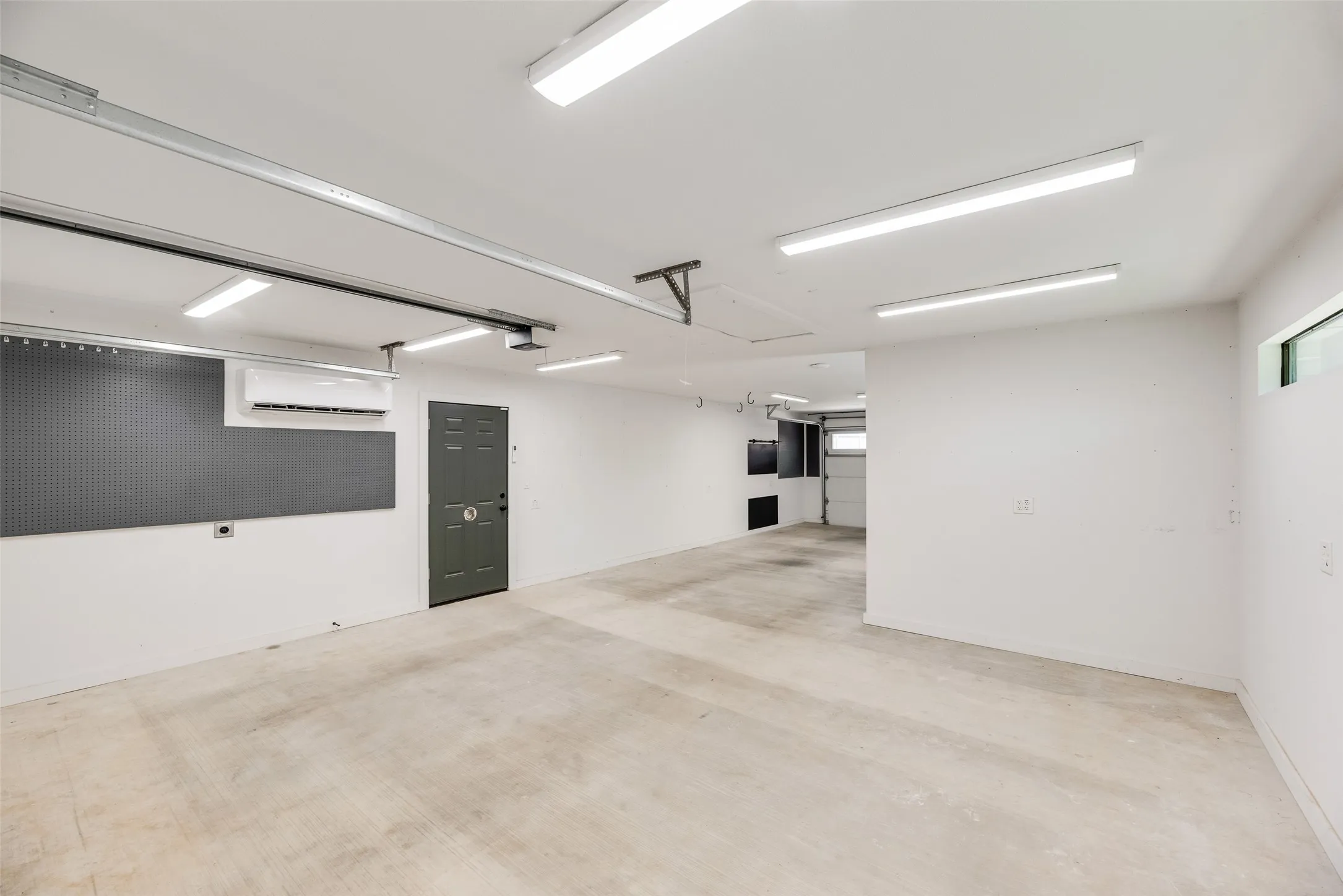 Garage featuring a wall mounted mini split