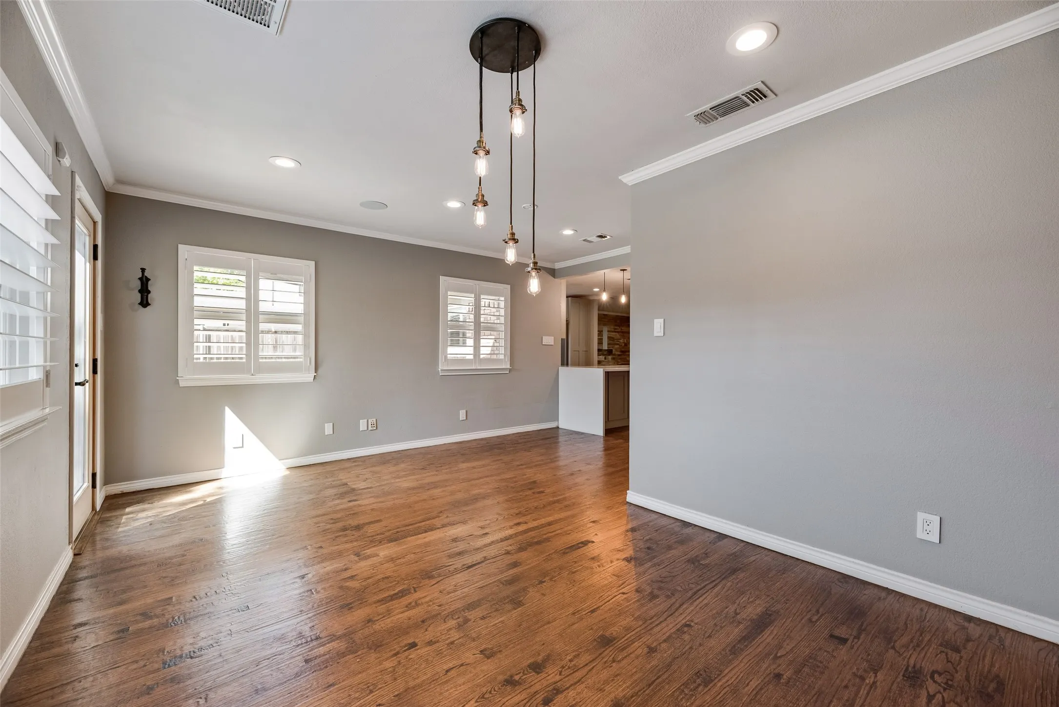Unfurnished room featuring ornamental molding, dark wood-style floors, and recessed lighting