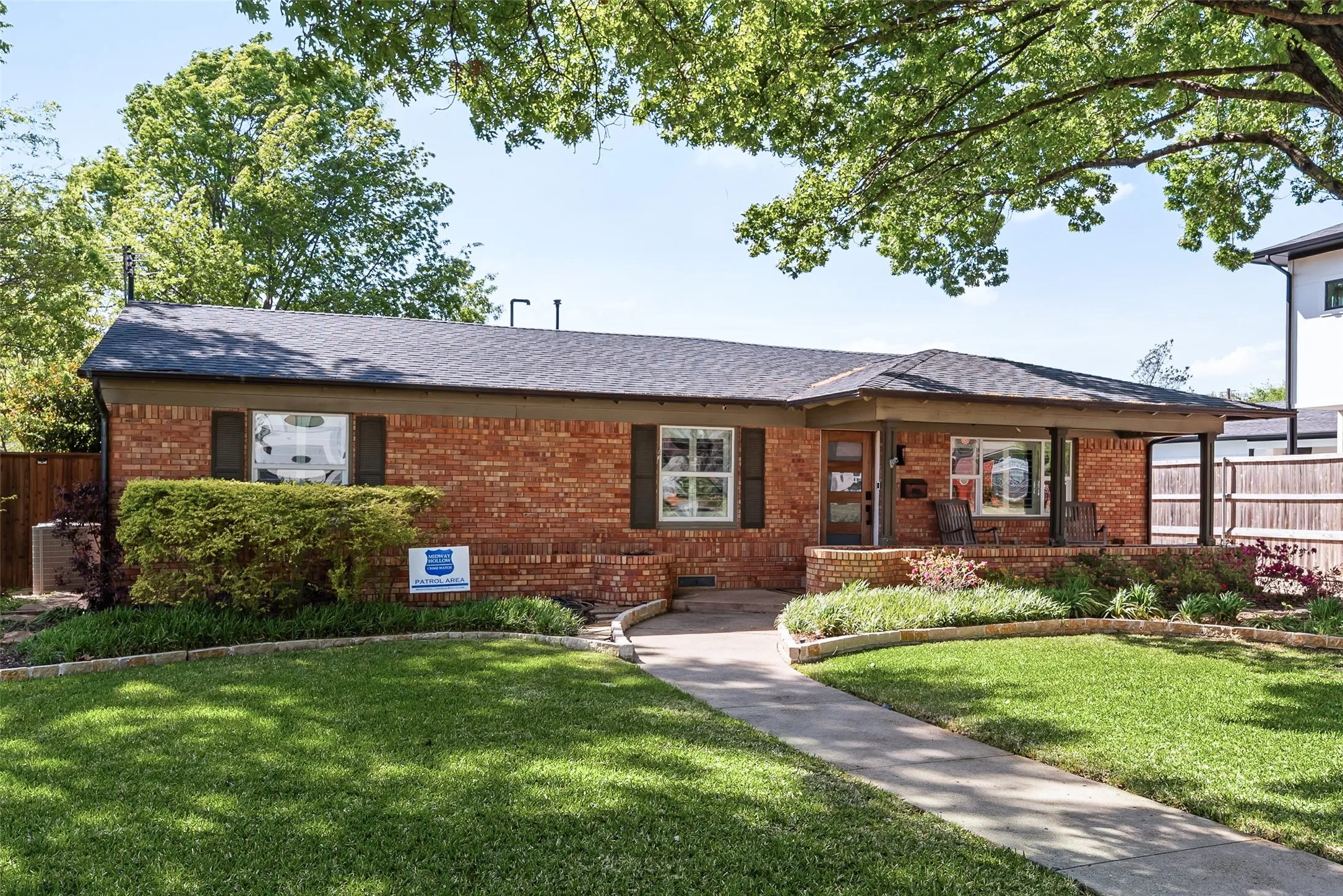 Single story home featuring brick siding and a shingled roof