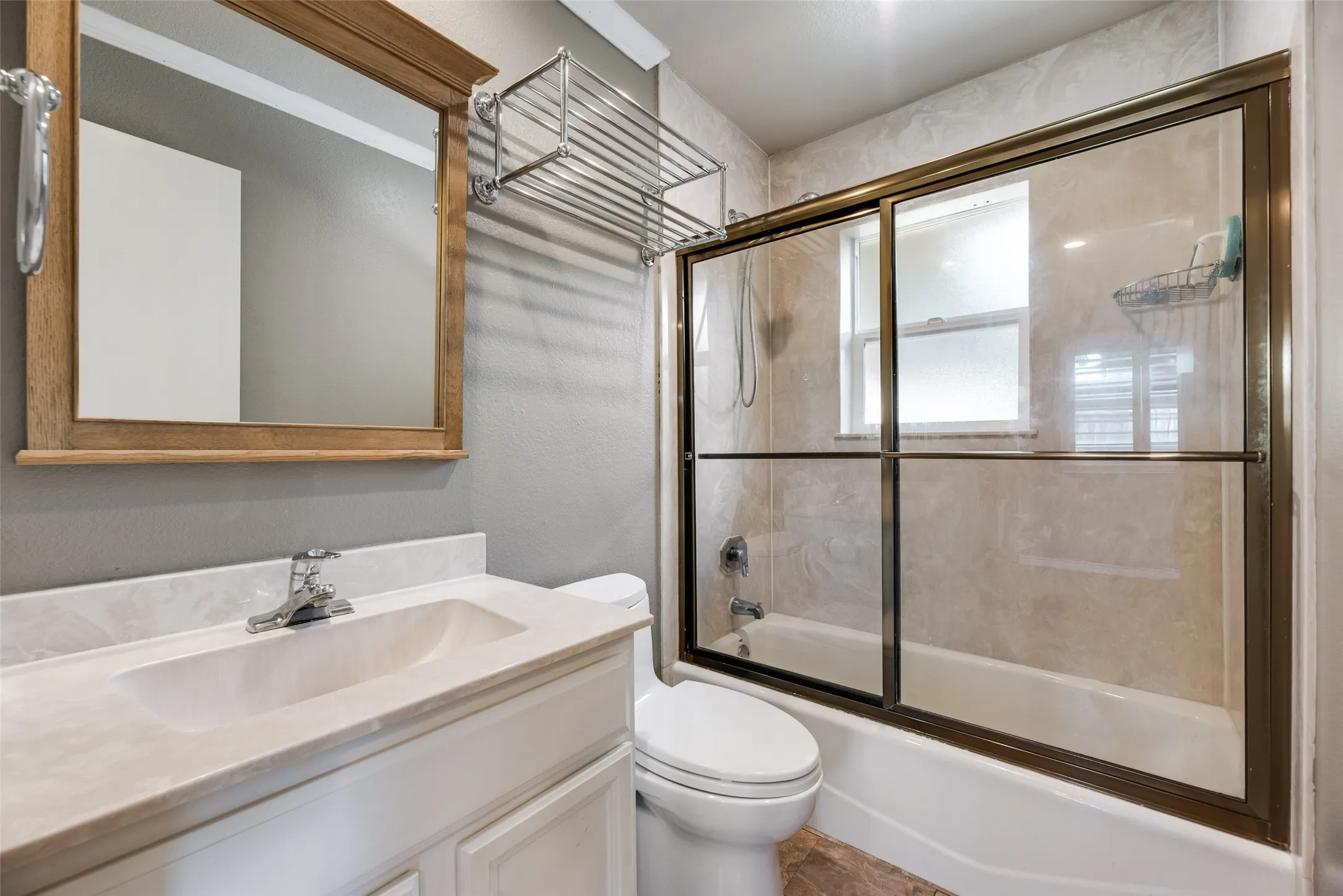 Bathroom with vanity and shower / bath combination with glass door