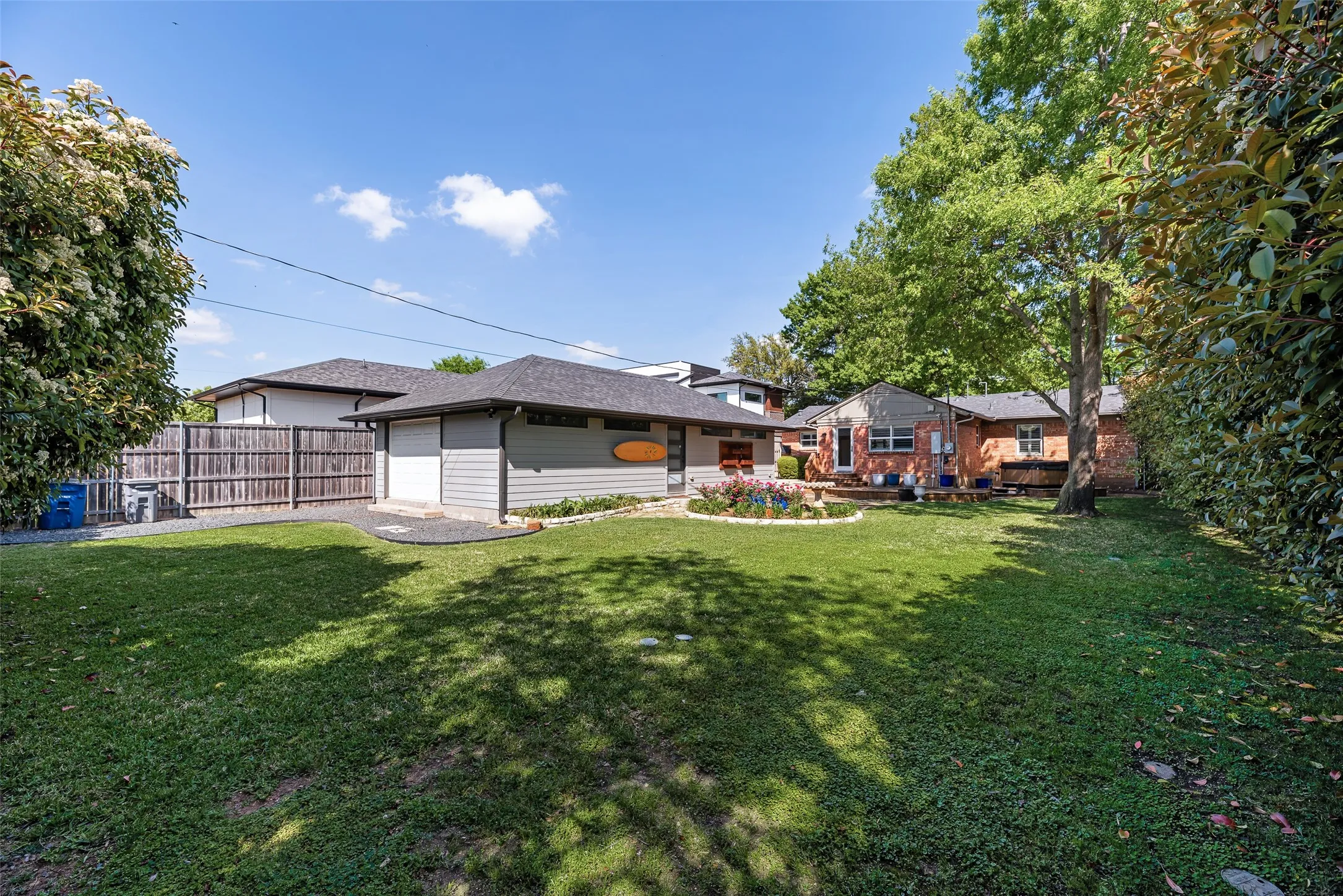 Back of property with a garage and an outbuilding
