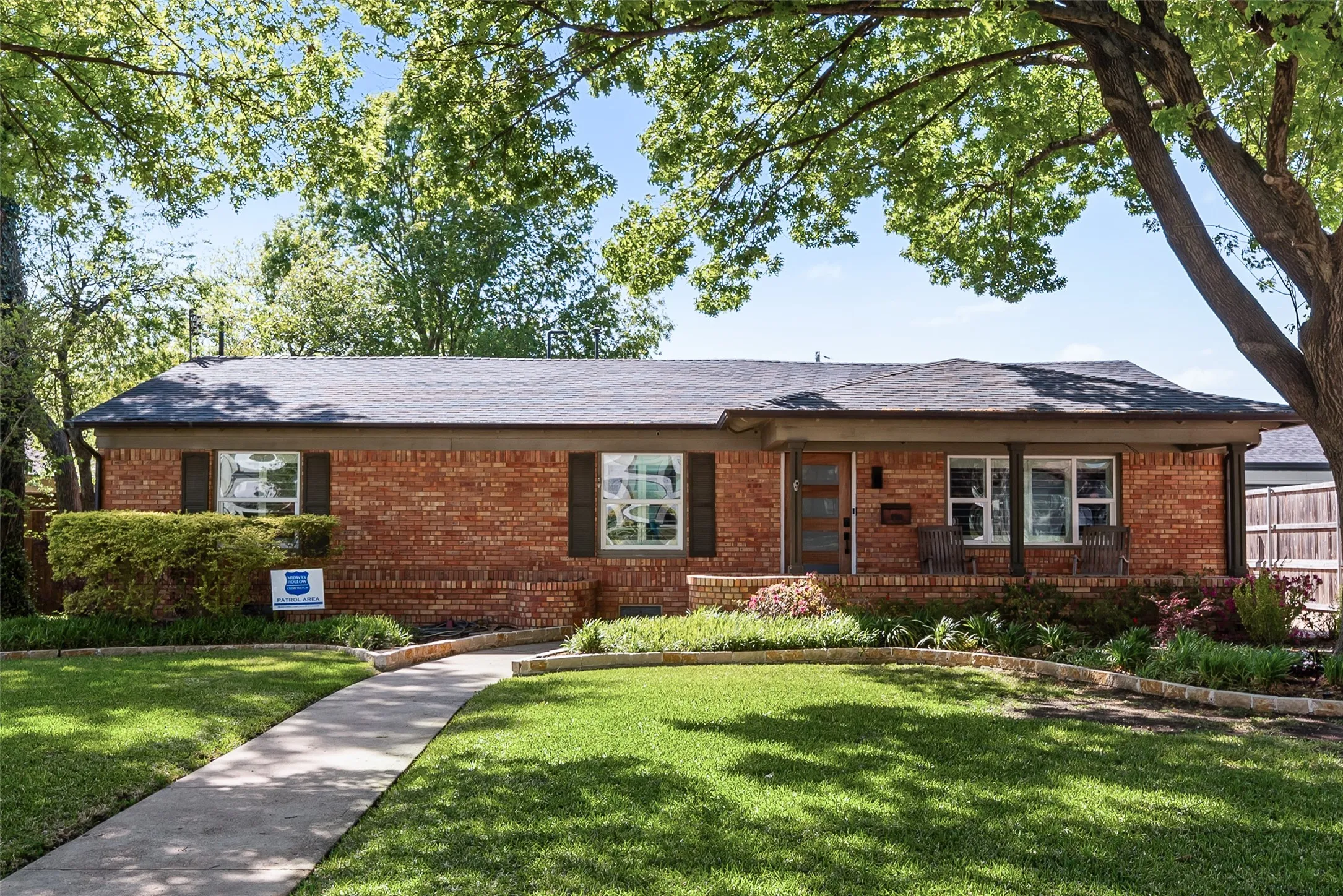 Ranch-style home featuring brick siding and a front lawn