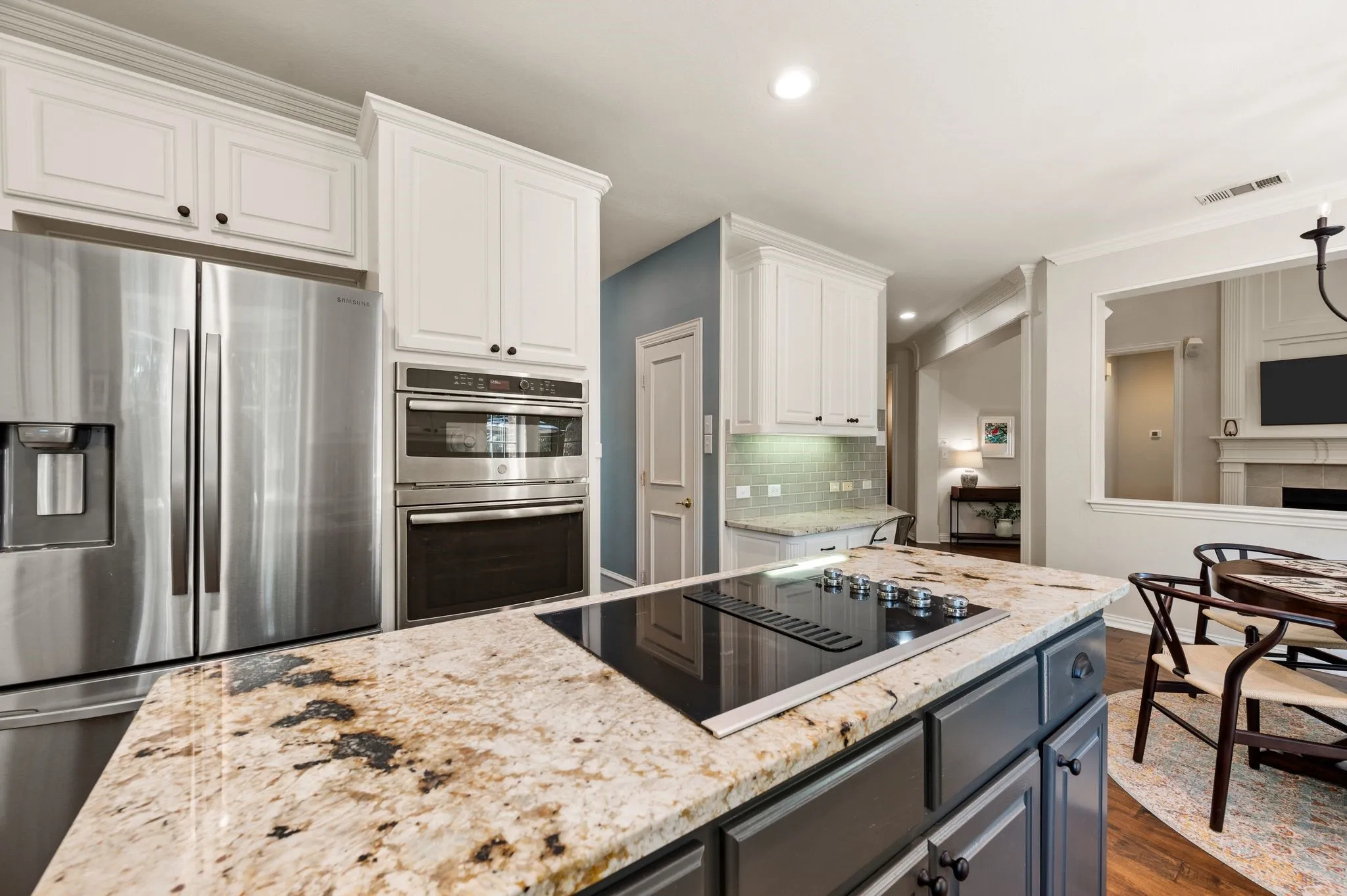 Stainless steel appliances, double ovens & an island cooktop add style and functionality to this well-appointed kitchen.