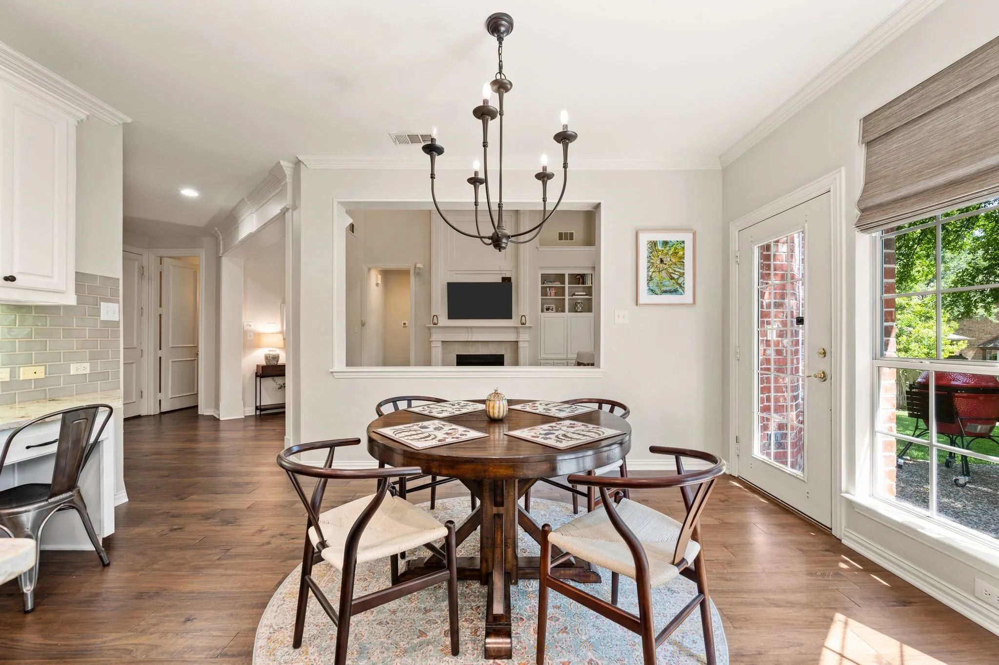 Sun-filled breakfast area enjoys backyard access and a convenient pass-through overlooking the family room.