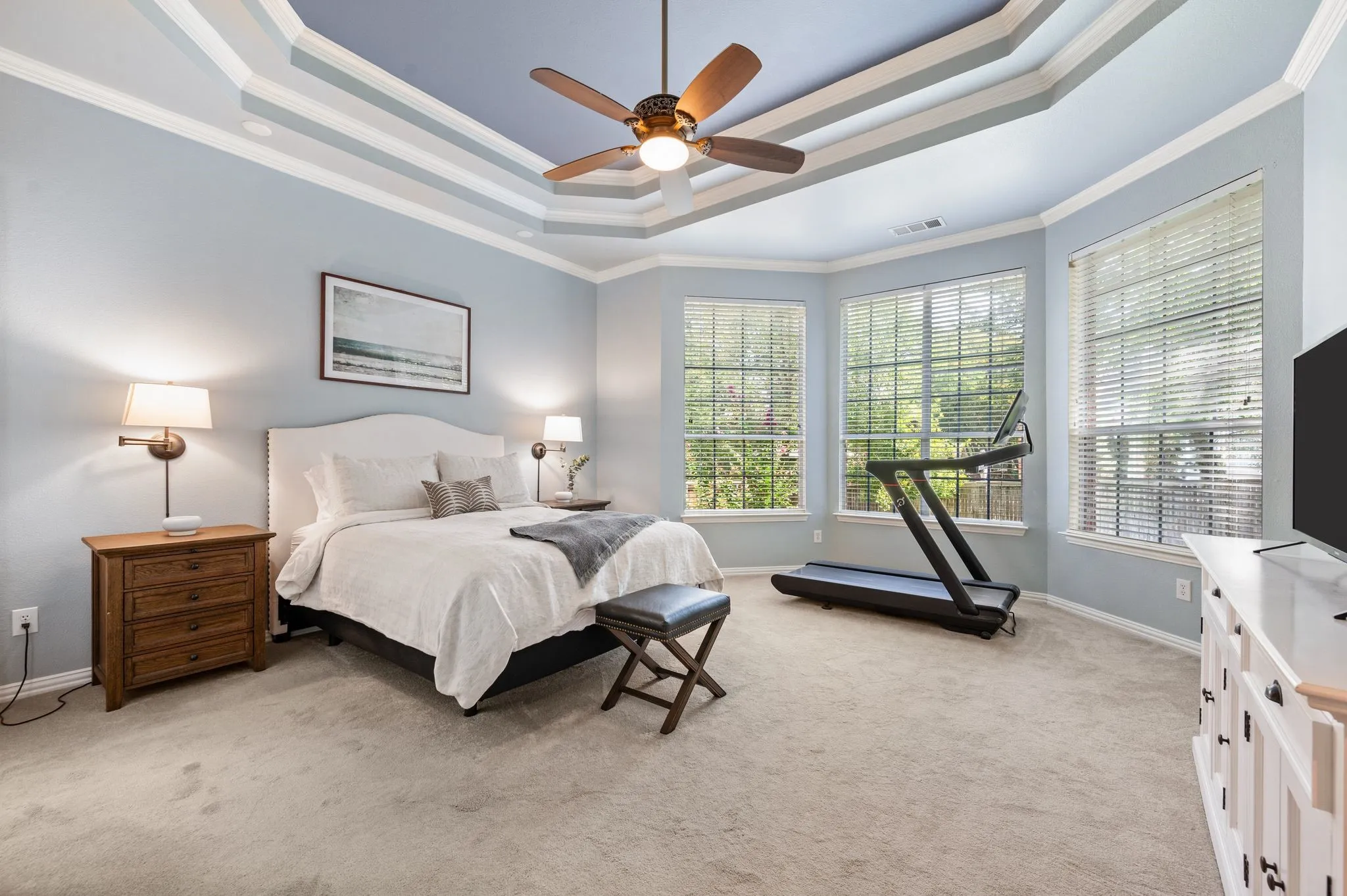 Walls of windows fill the oversized owner’s suite with natural light, while the dramatic ceiling adds a beautiful architectural touch.