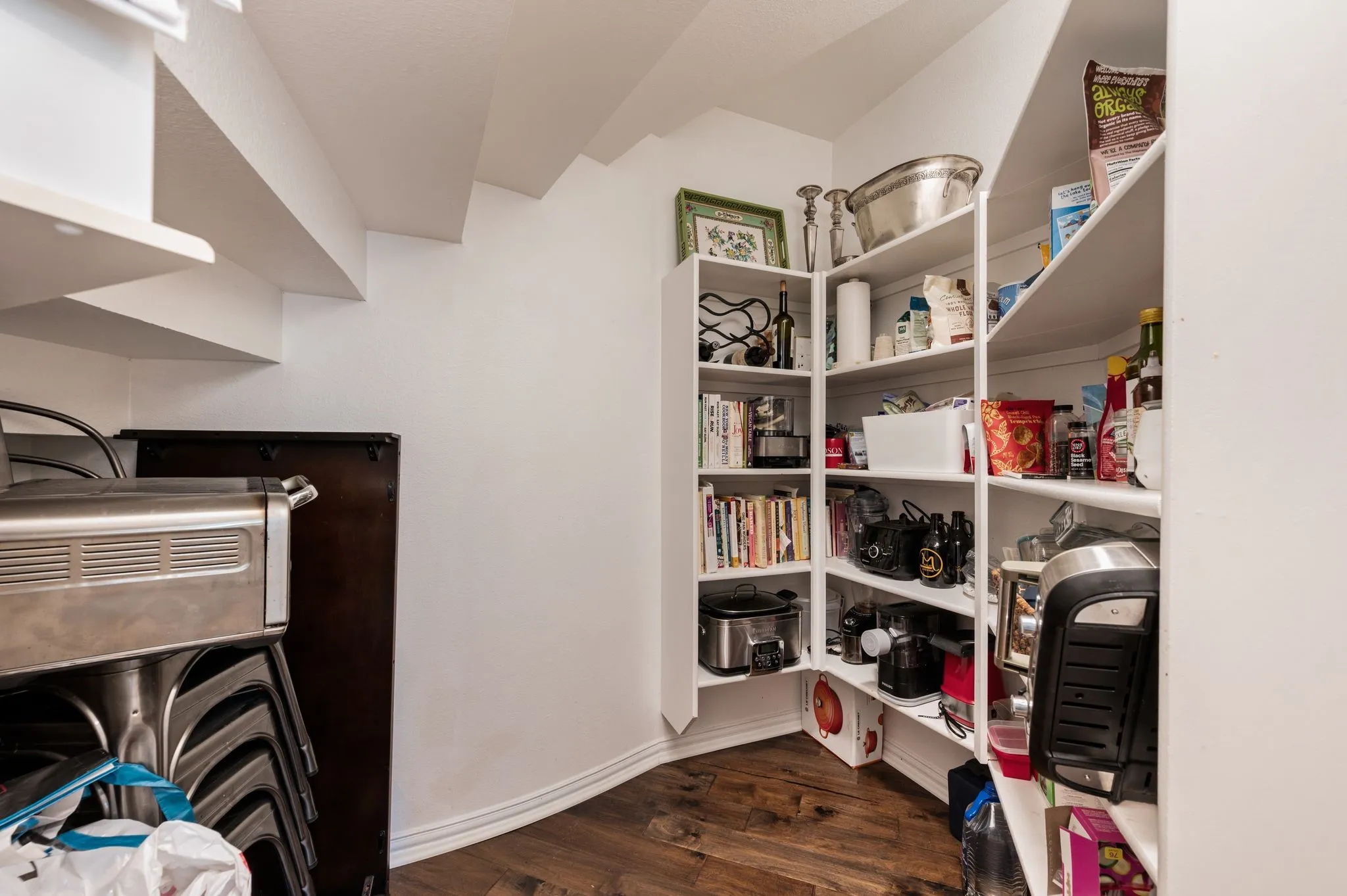 Oversized walk-in pantry offers extensive shelving and impressive storage for groceries, appliances & entertaining essentials.