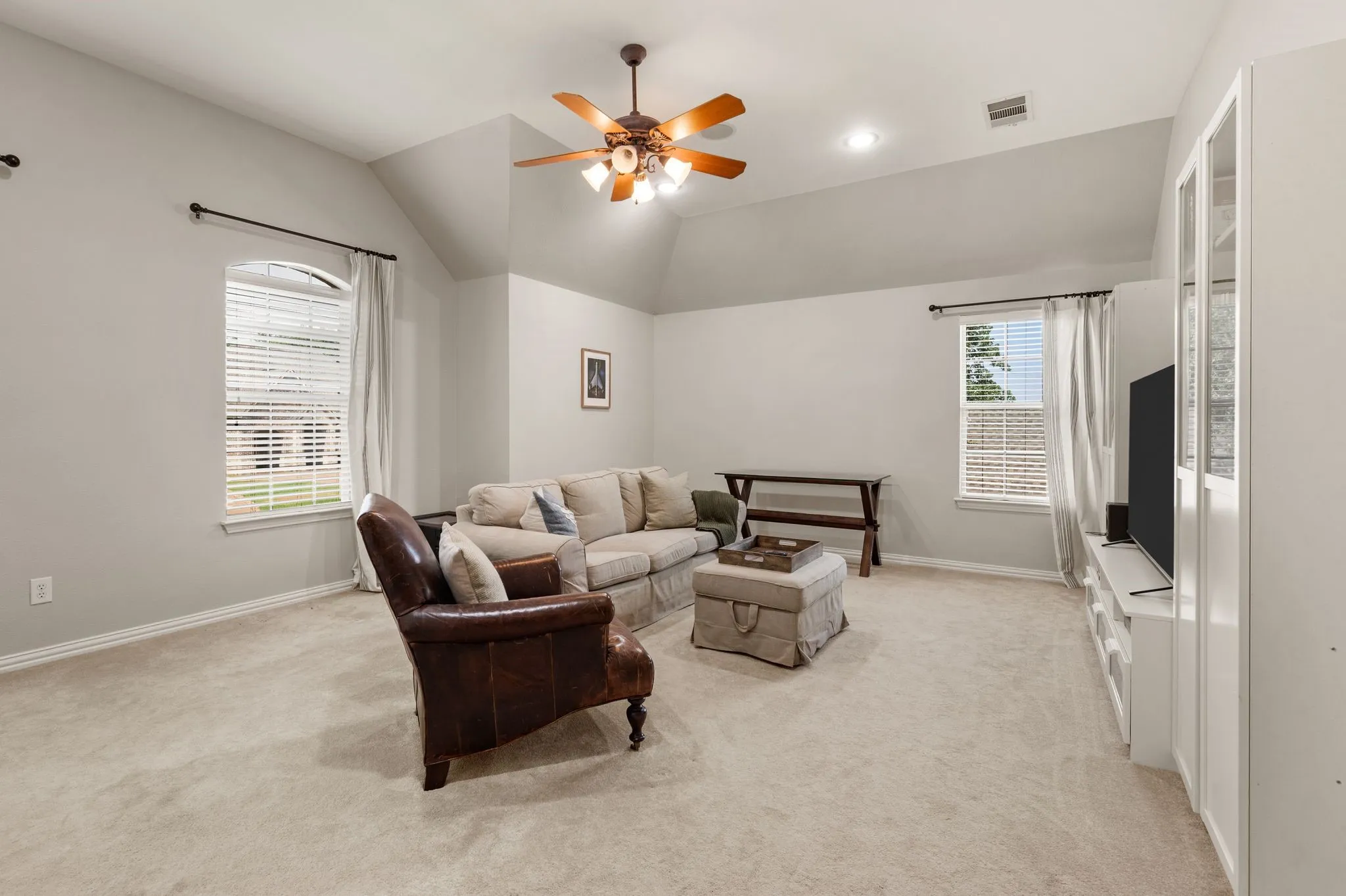 Another view of the expansive game room highlights vaulted ceilings, plentiful natural light & flexible space for multiple activity zones.