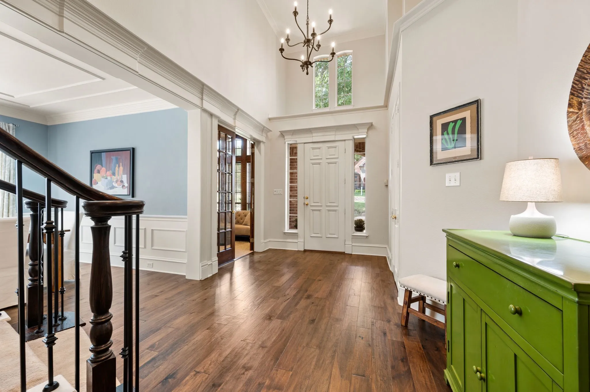 Soaring ceilings, warm wood floors & graceful architectural details create a bright and impressive entry.