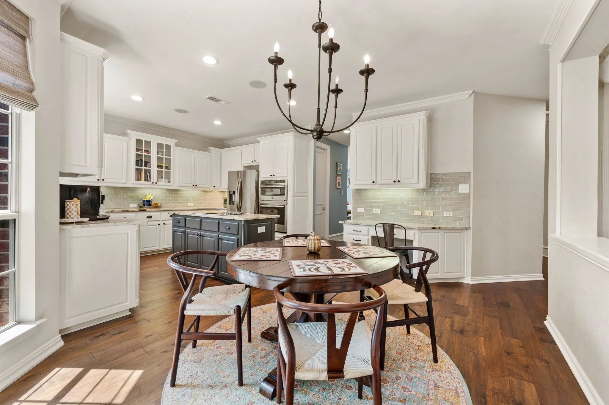 Bright breakfast nook provides an inviting spot for casual meals, with nearby built-in cabinetry ideal for a coffee bar or workspace.