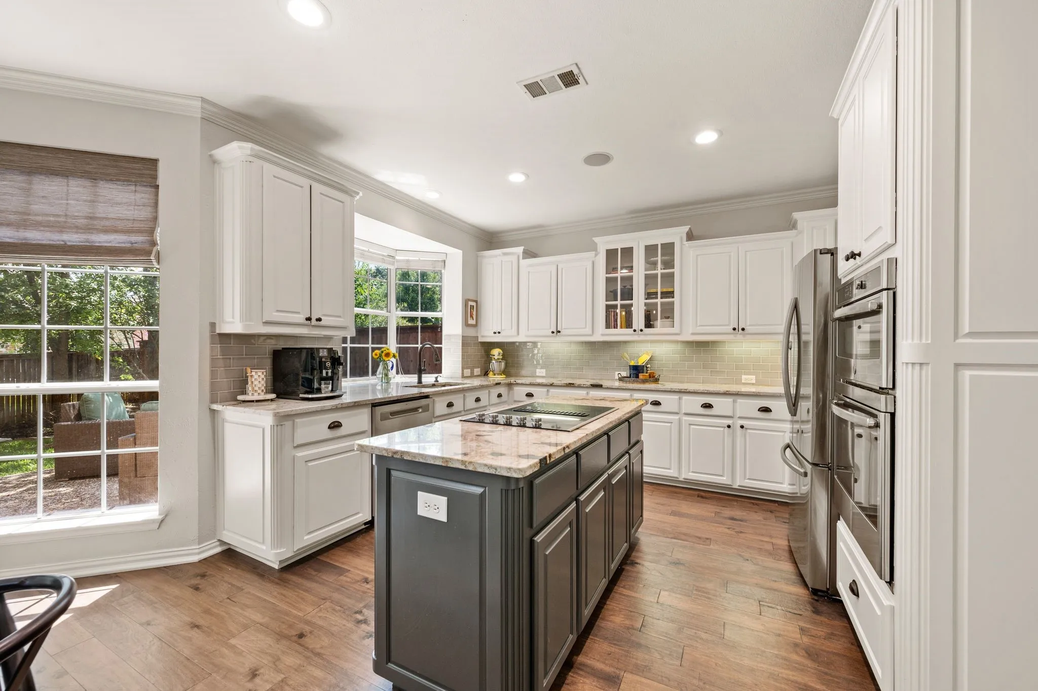A large center island anchors the kitchen while generous counter space & extensive cabinetry make cooking and entertaining a breeze.
