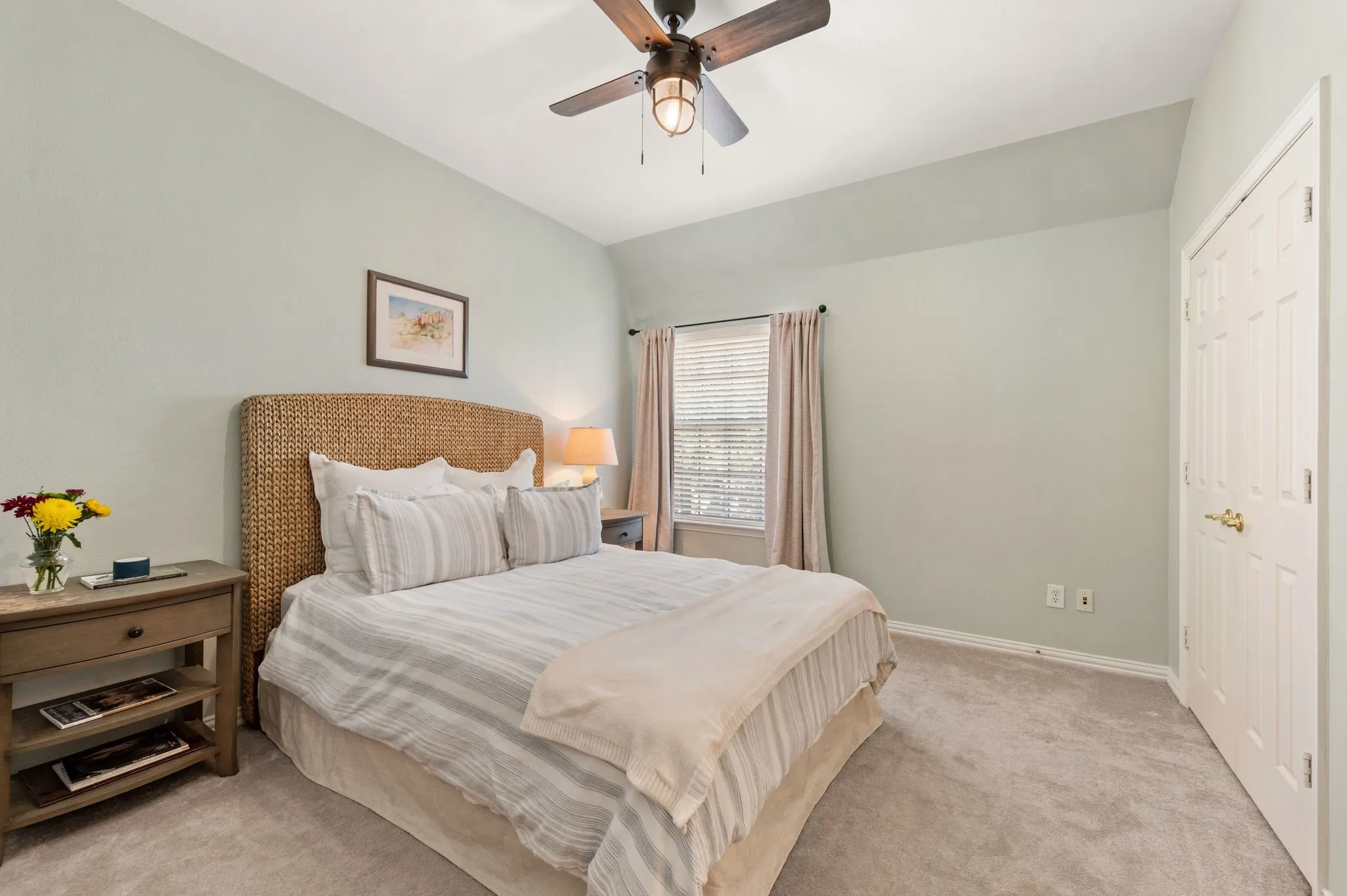 Comfortable secondary bedroom features a vaulted ceiling, ceiling fan, generous closet & soothing neutral palette.