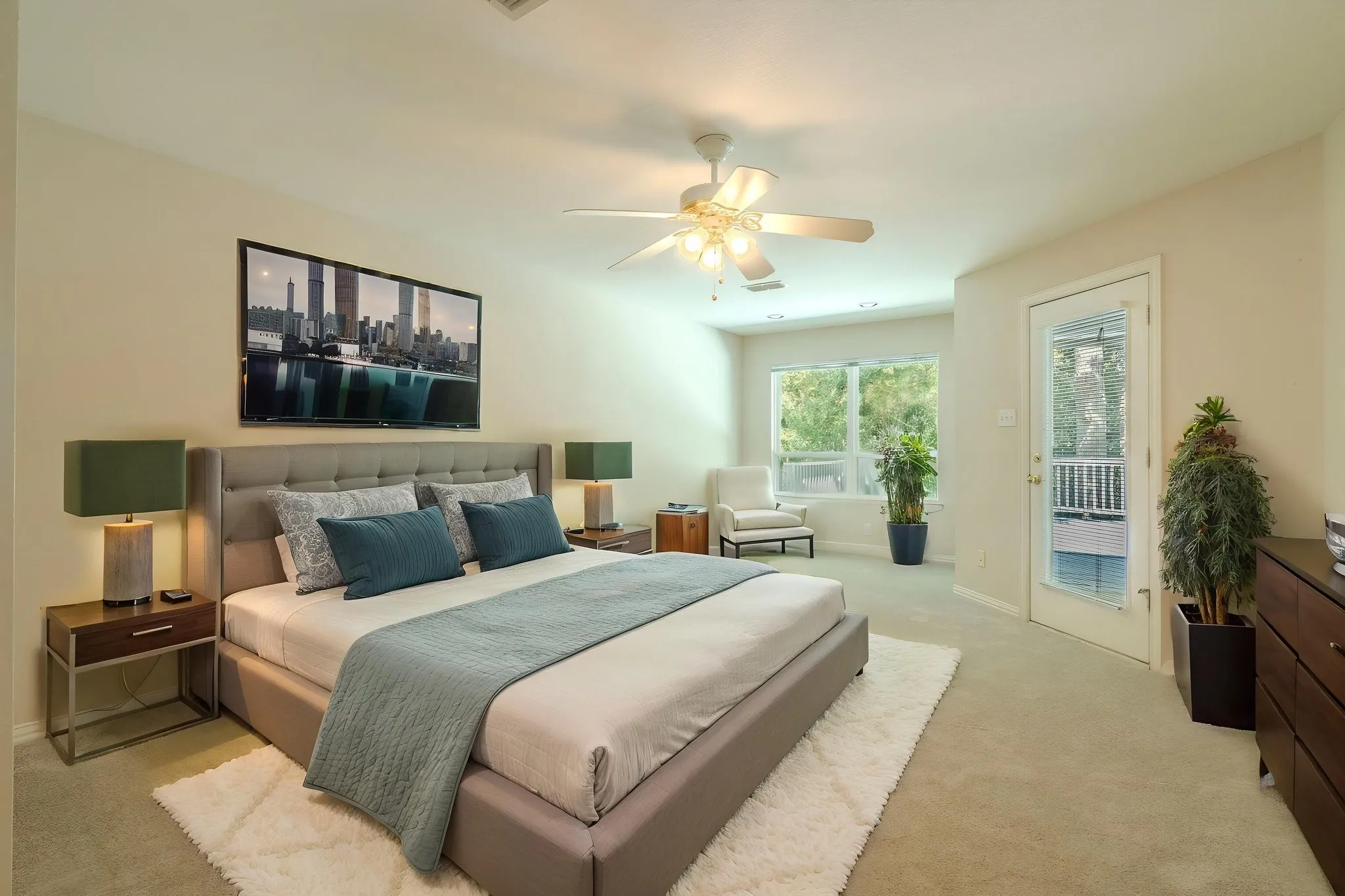 The spacious primary bedroom with NEW carpet features a sitting area; a private exit to the back yard deck; and an ensuite bath. Virtually staged
