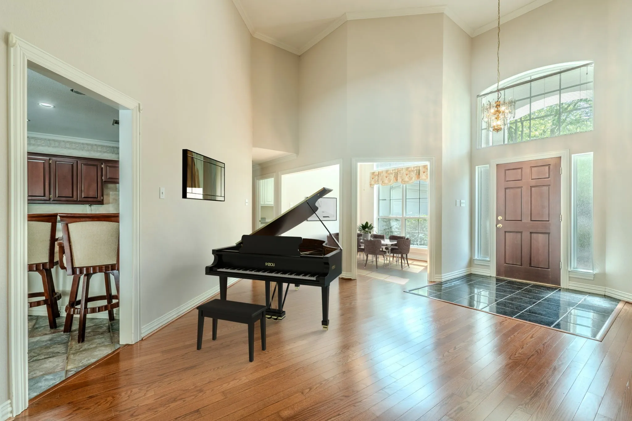 The living room just off the entry has plenty of room and is flanked by the formal dining room (rear of this photo) and the kitchen/breakfast area on the left. Virtually staged.
