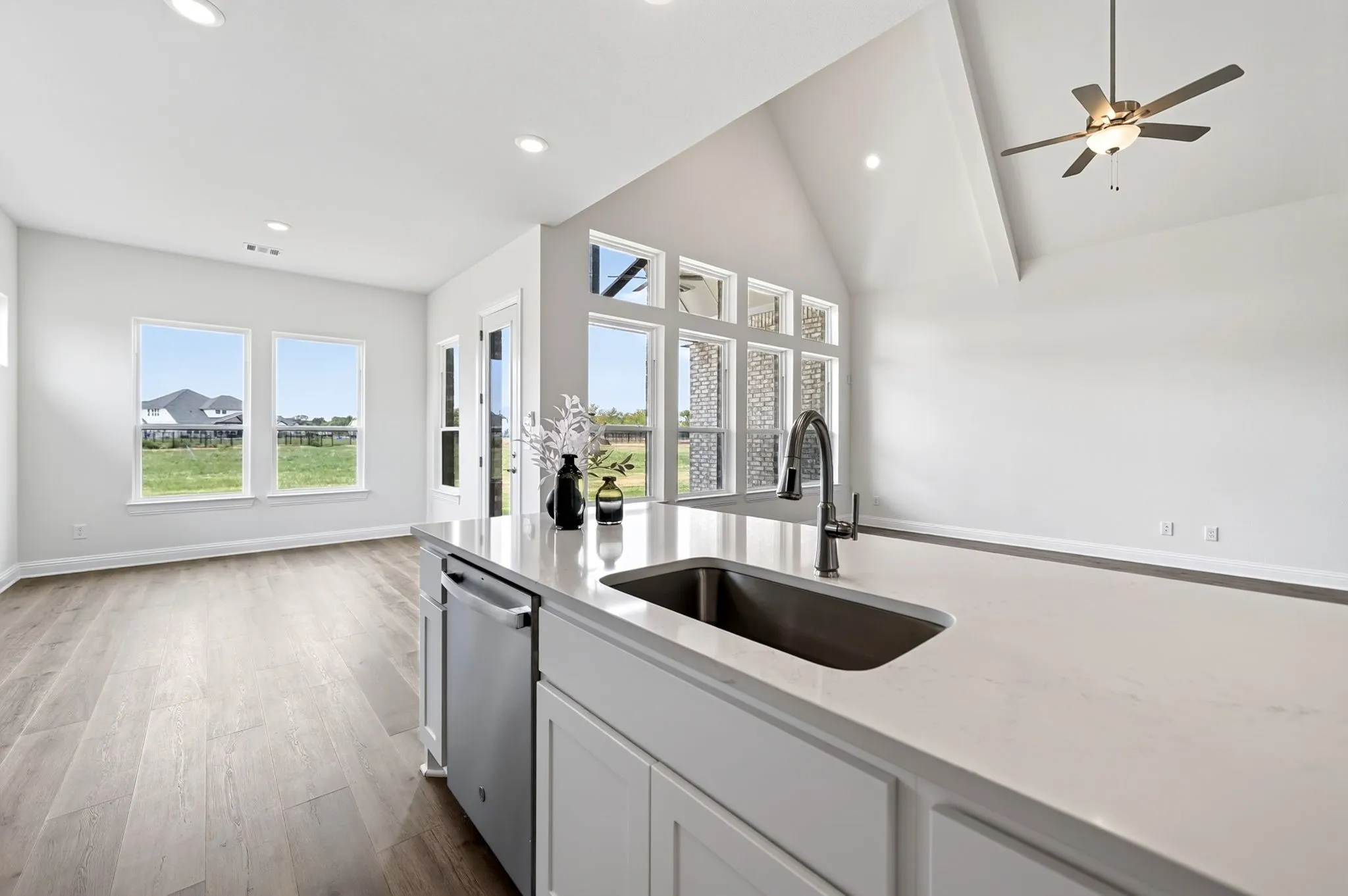 Kitchen island with an undermount sink, gooseneck faucet, and stainless steel dishwasher