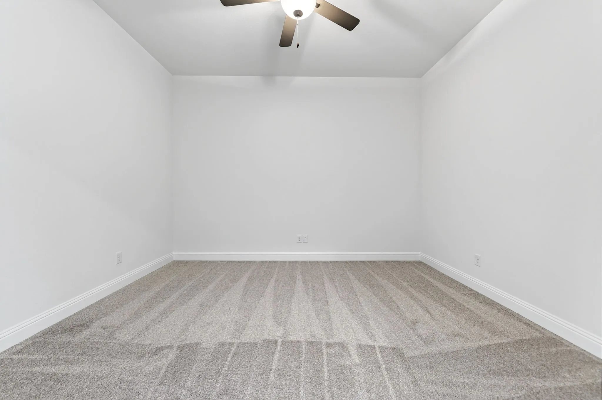 Neutral wall color, carpet flooring, and a ceiling fan with integrated lighting