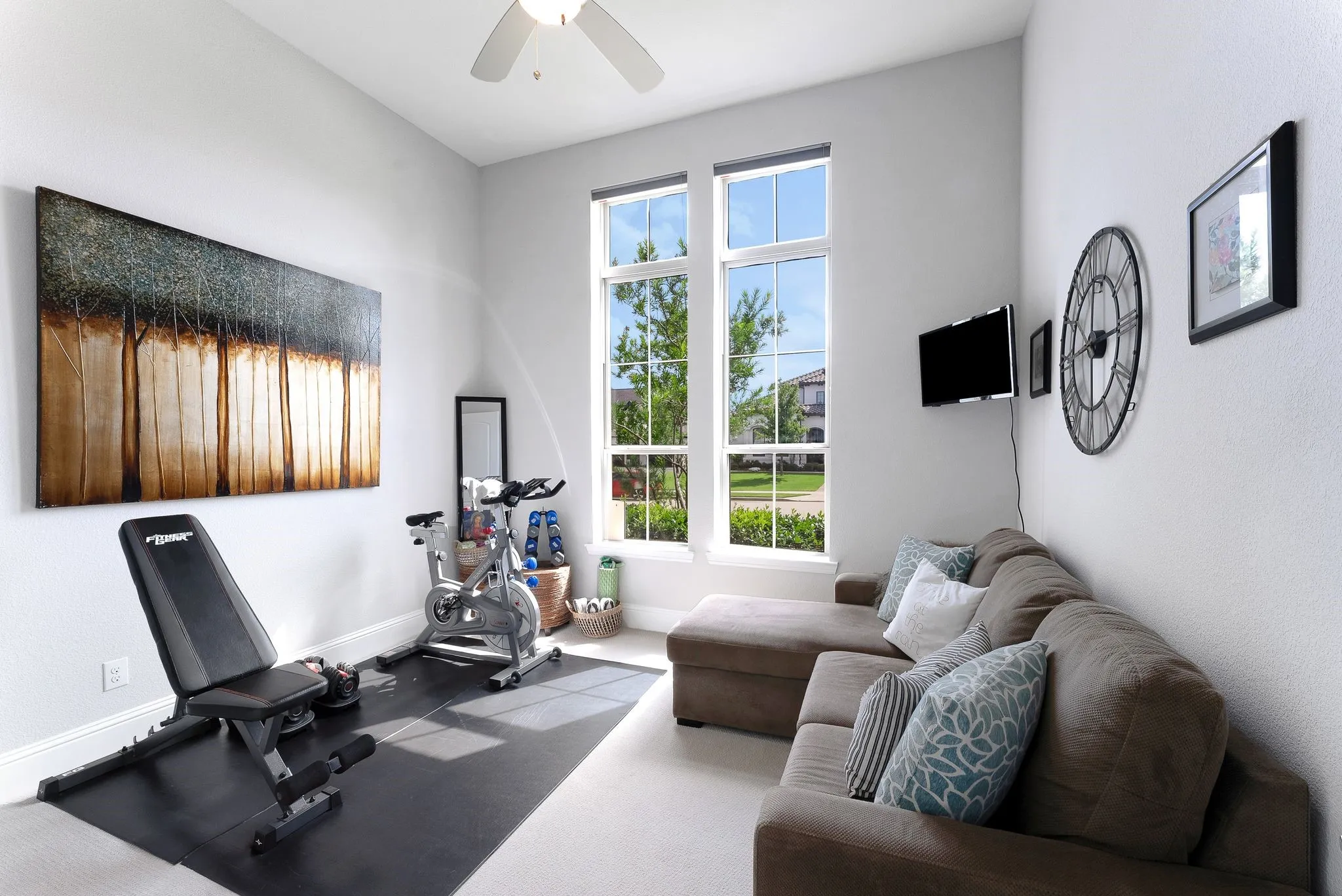 Room with high ceilings, ceiling fan, and large windows