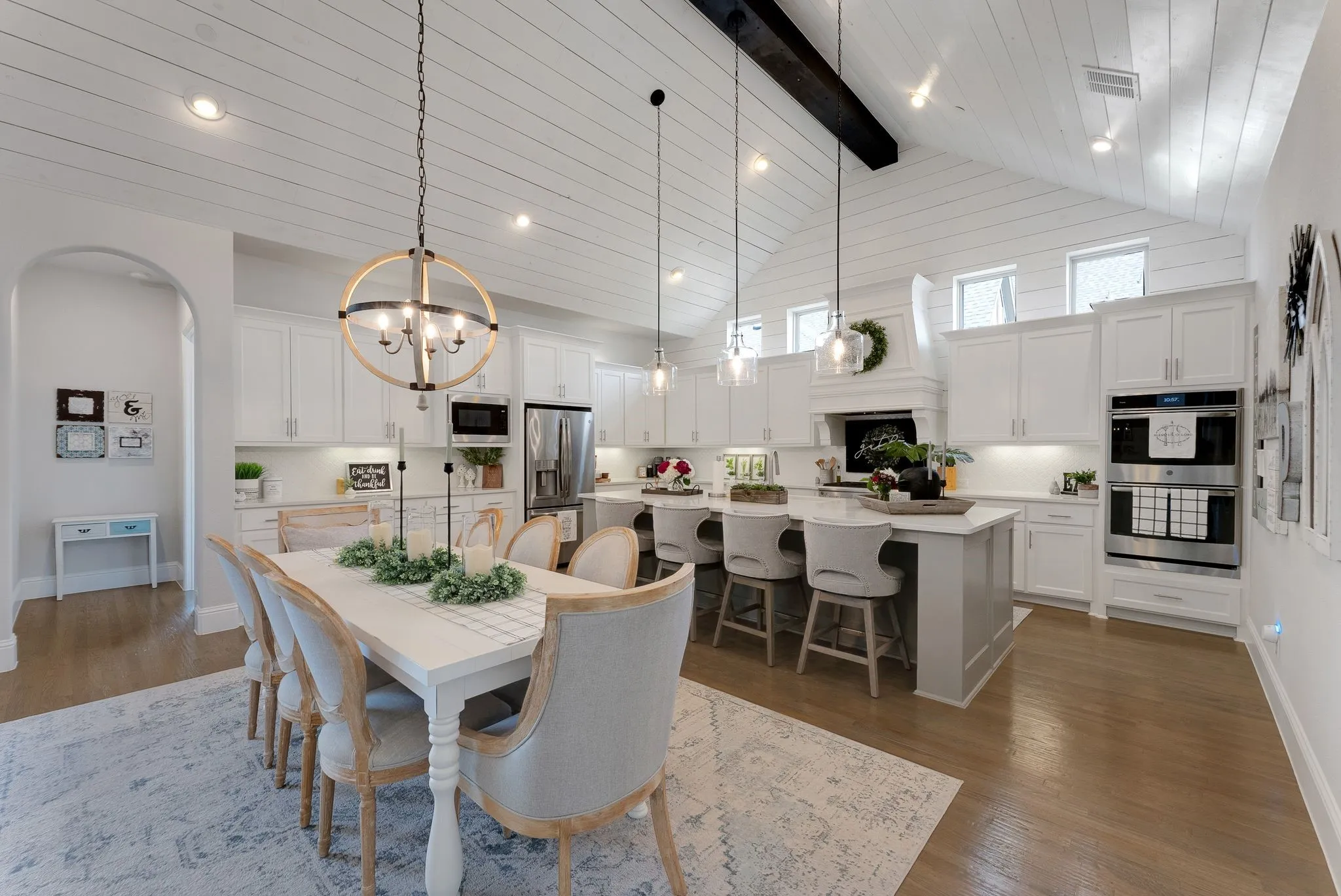 Vaulted shiplap ceiling with exposed beam, recessed lighting, and wood-finish flooring