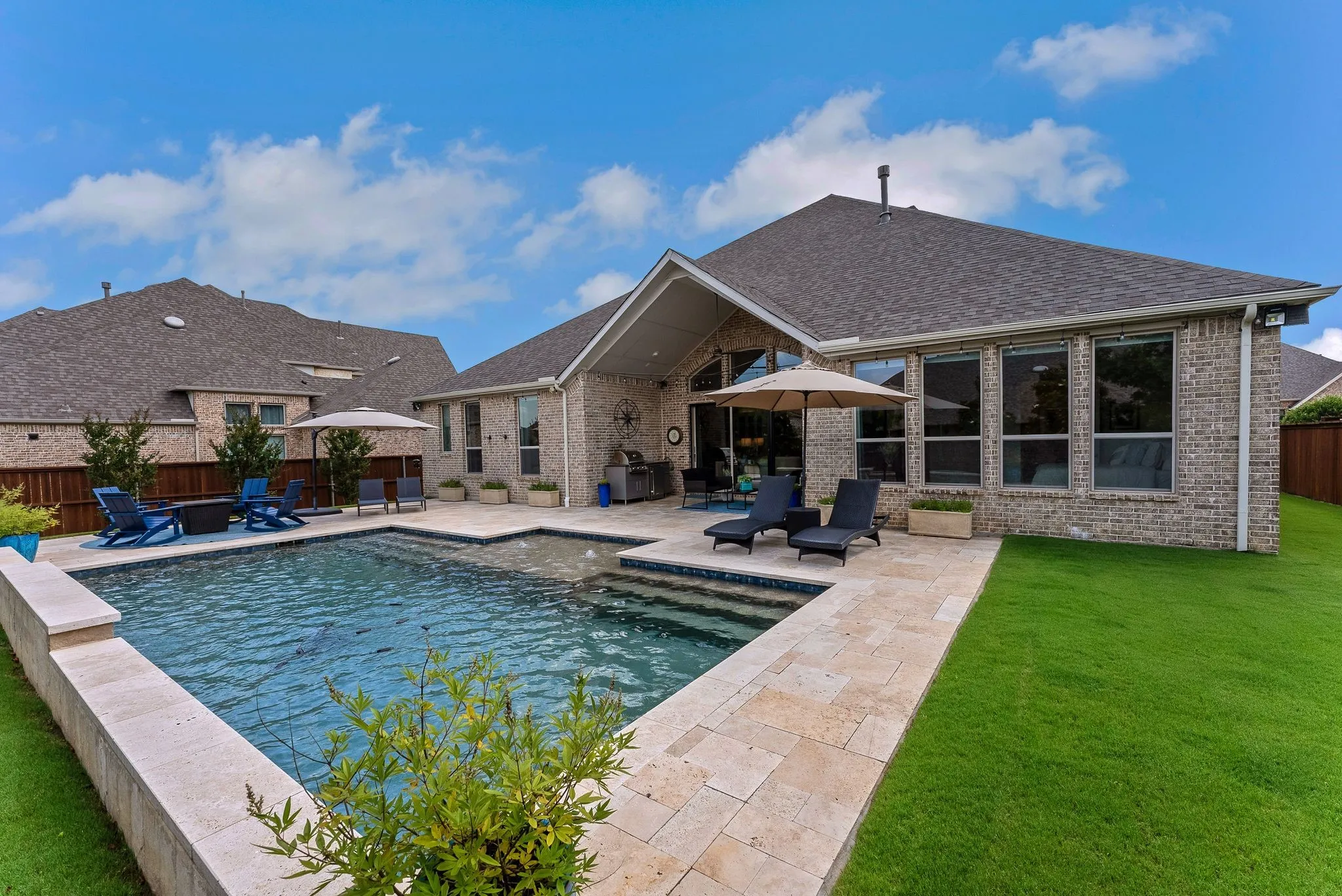 Brick exterior with a gabled roof and a private pool
