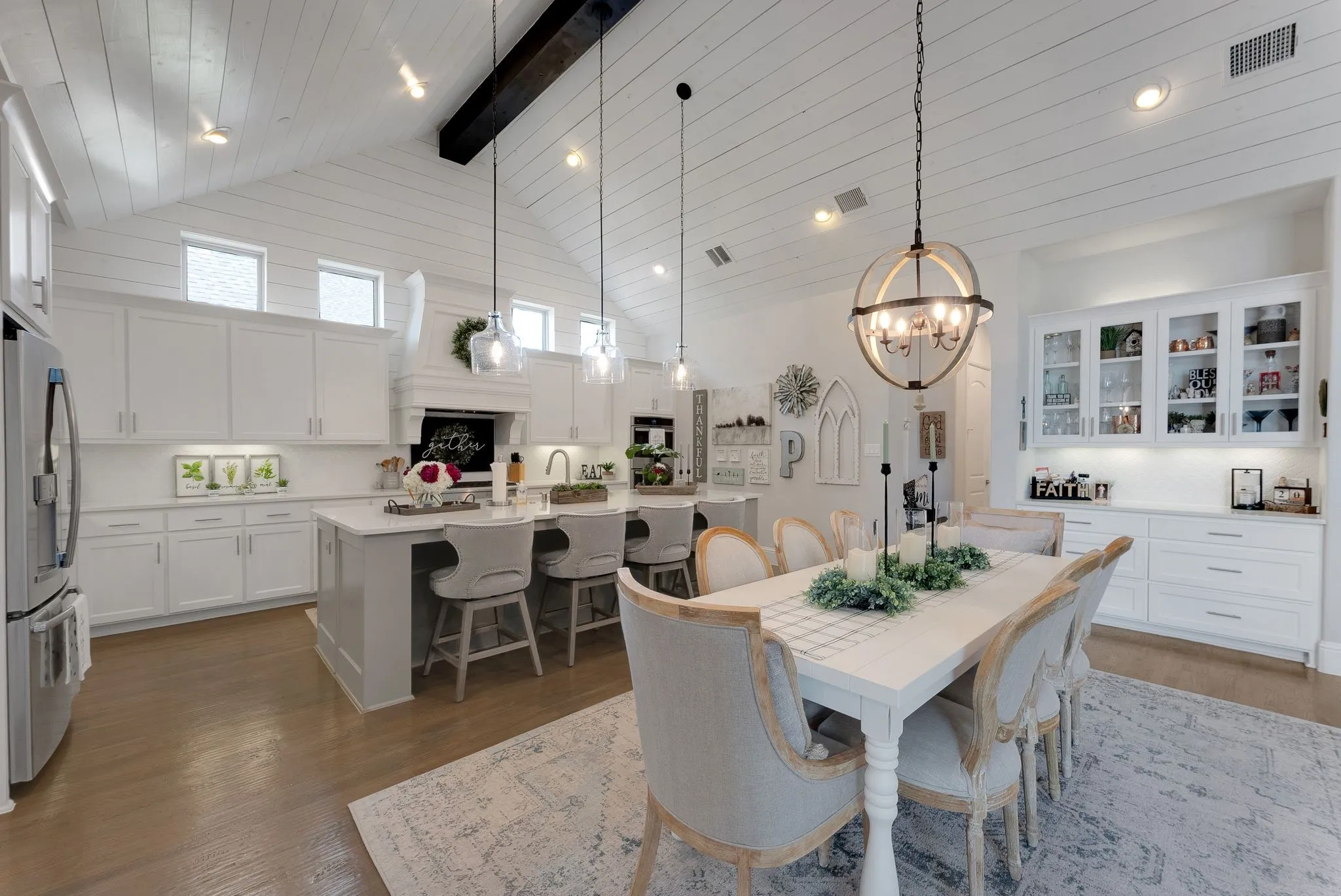 Vaulted shiplap ceiling with exposed beam, recessed lighting, and clerestory windows