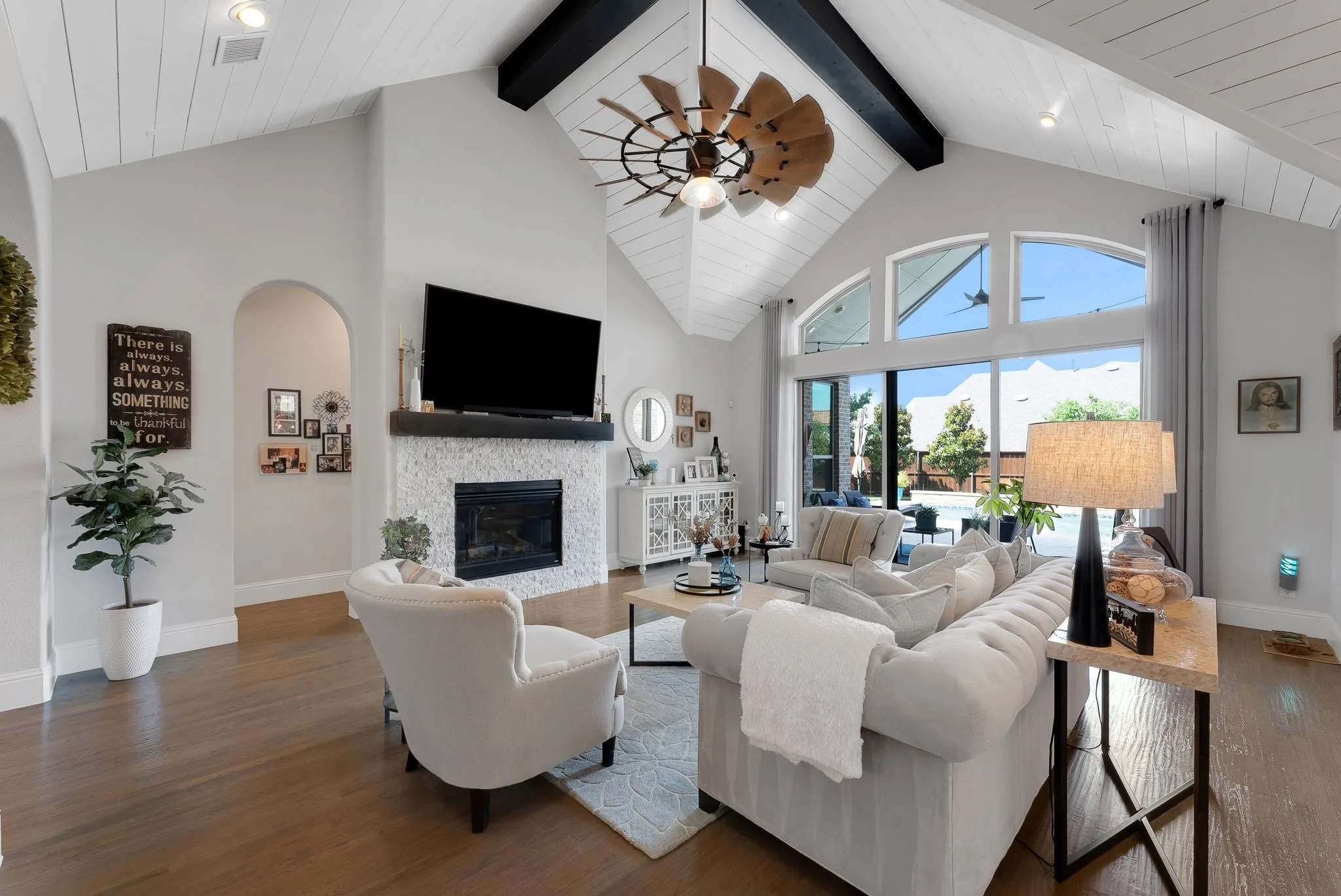 Vaulted ceiling with exposed beam and wood-finish paneling