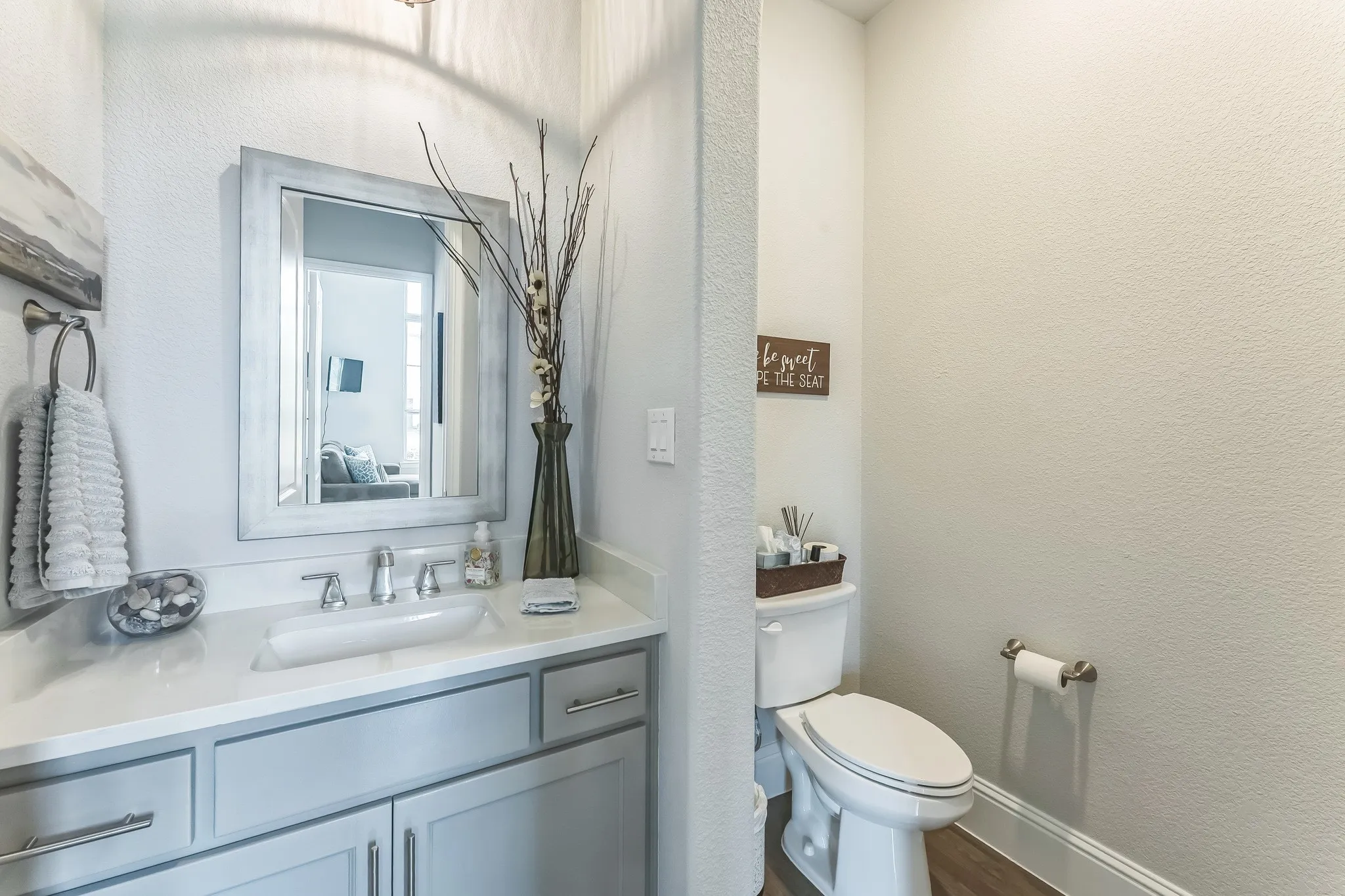 Vanity with an integrated sink, polished chrome faucet, and light-toned cabinetry