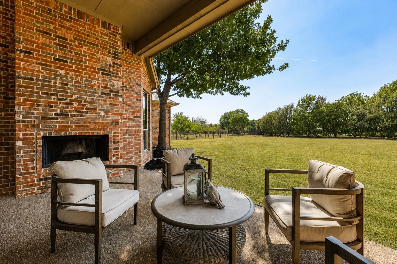 Covered patio with outdoor fireplace.