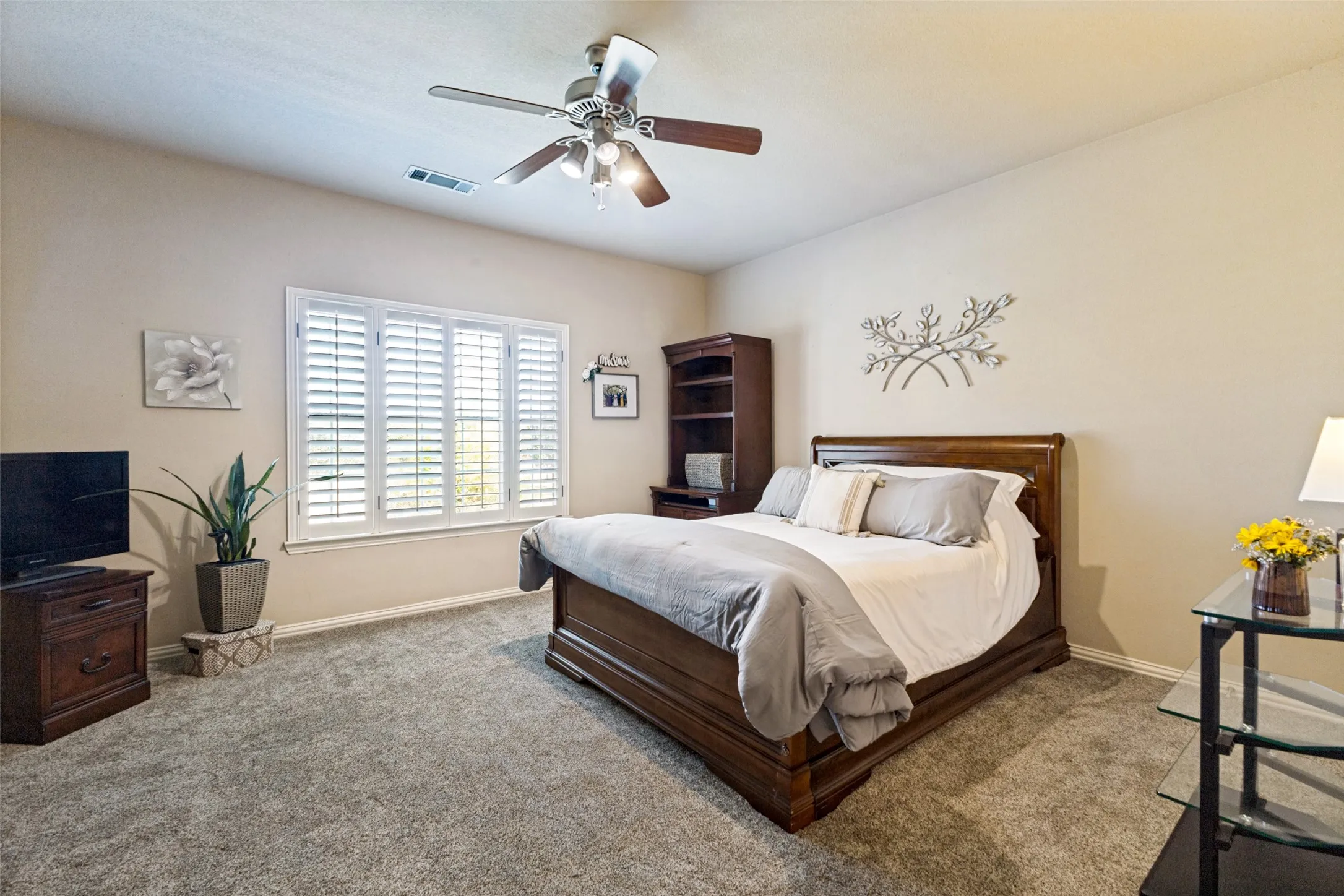 Upstairs bedroom with ceiling fan.