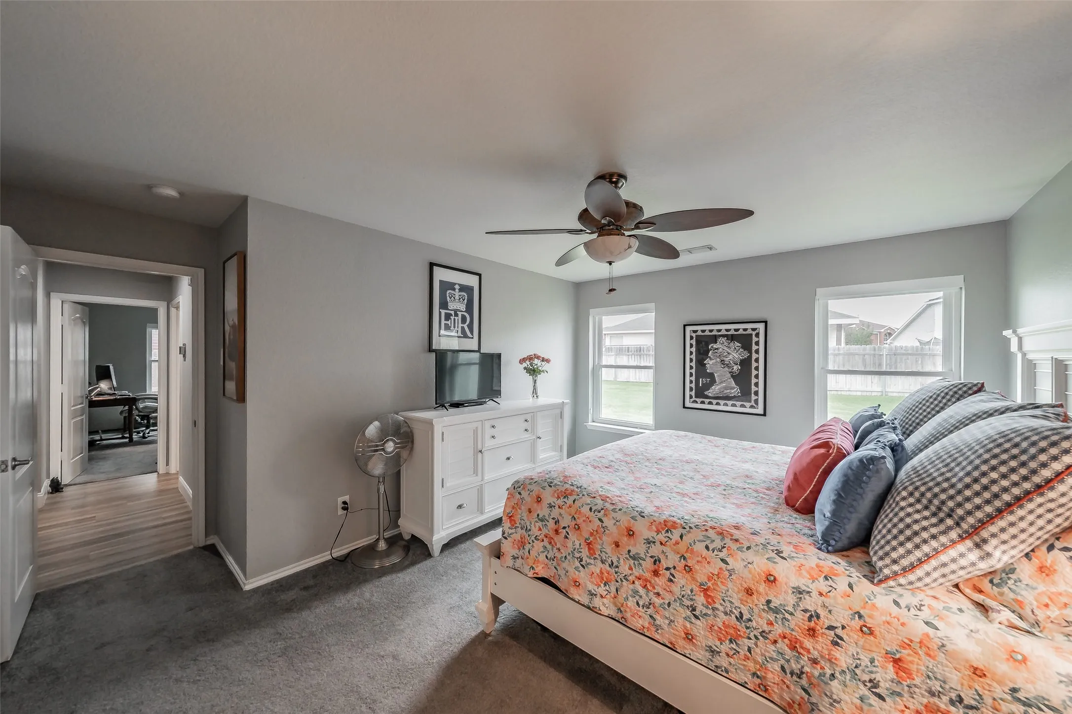Recessed lighting, ceiling fan, carpet flooring, multiple windows, and a built-in dresser