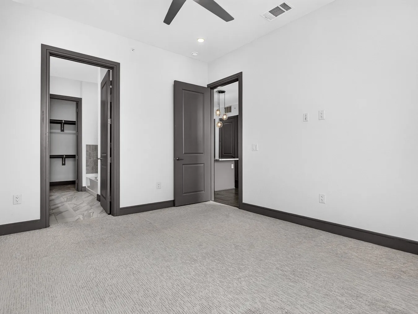 Textured carpet flooring, dark trim and door frames, recessed lighting, and a ceiling fan