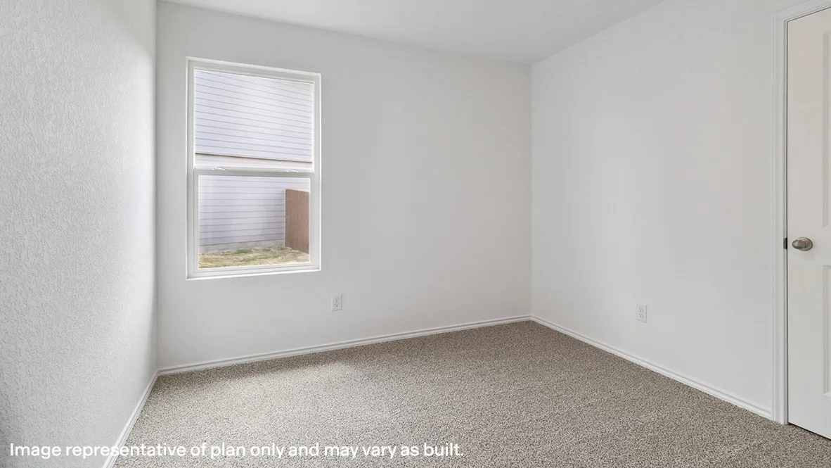 Bright bedroom featuring neutral carpet flooring, a large window with horizontal blinds providing natural light, and a spacious layout with clean white walls and a closet door