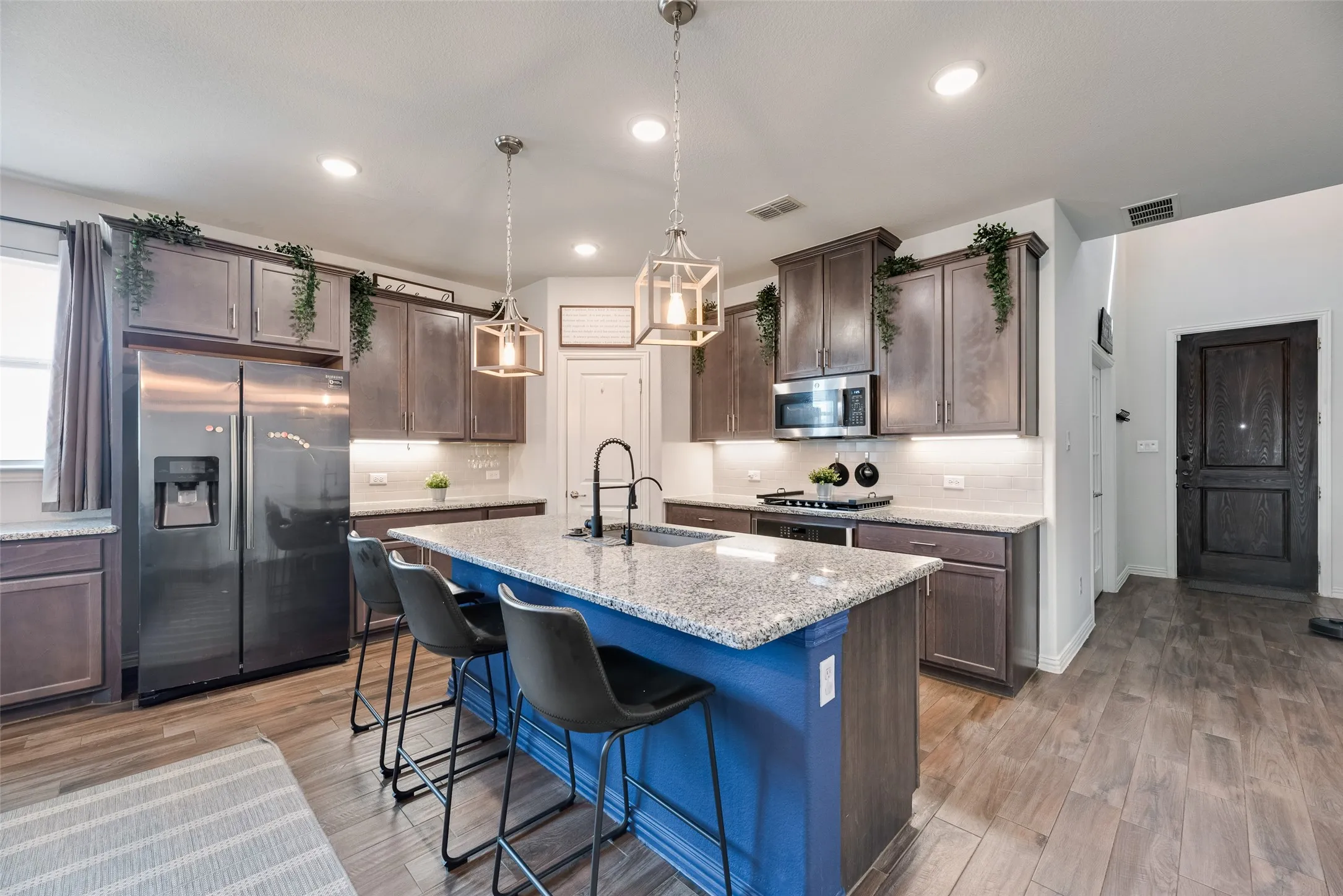 A perfect “Cook’s Kitchen” featuring a large island with seating and a gas cooktop!