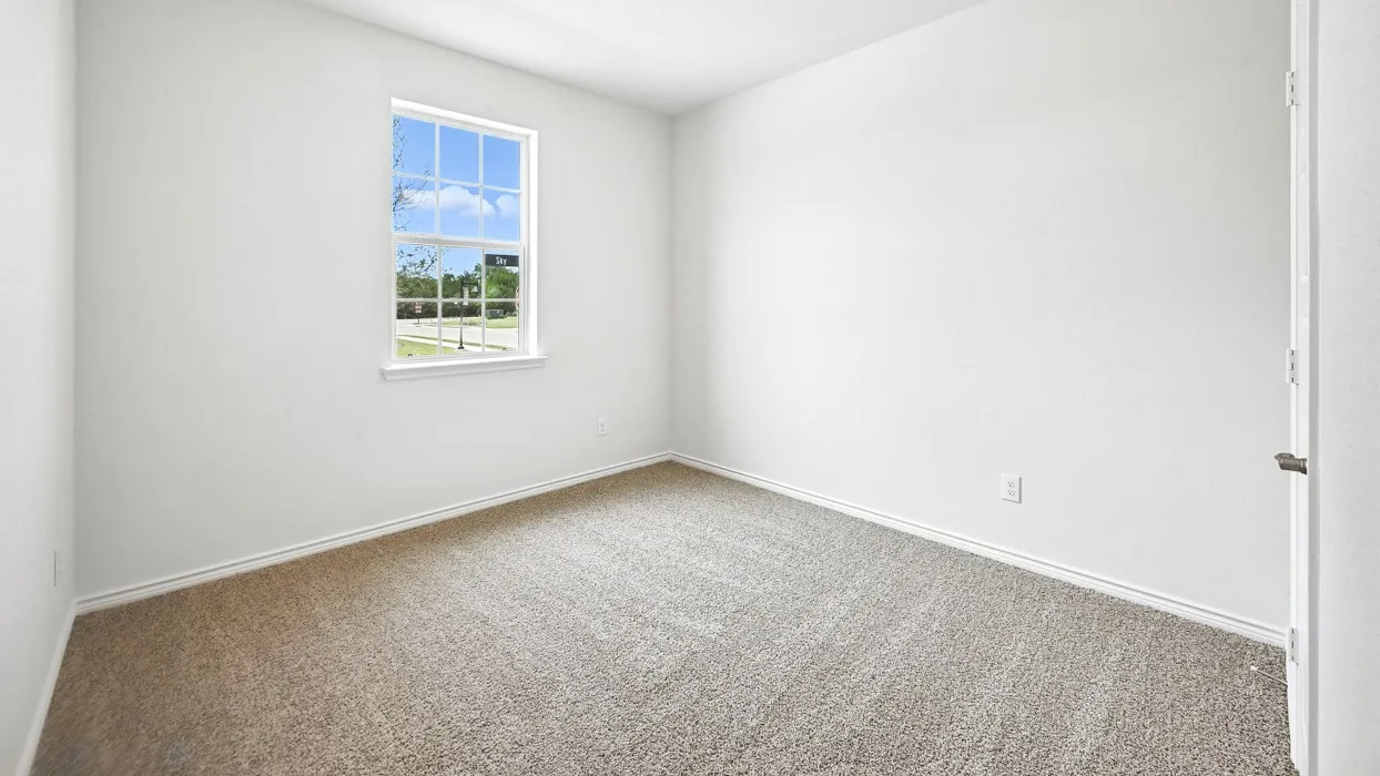 Light-filled room featuring neutral-toned carpeting, white painted walls, and a white-framed double-hung​​‌​​​​‌​​‌‌​‌‌​​​‌‌​‌​‌​‌​​​‌​​ window