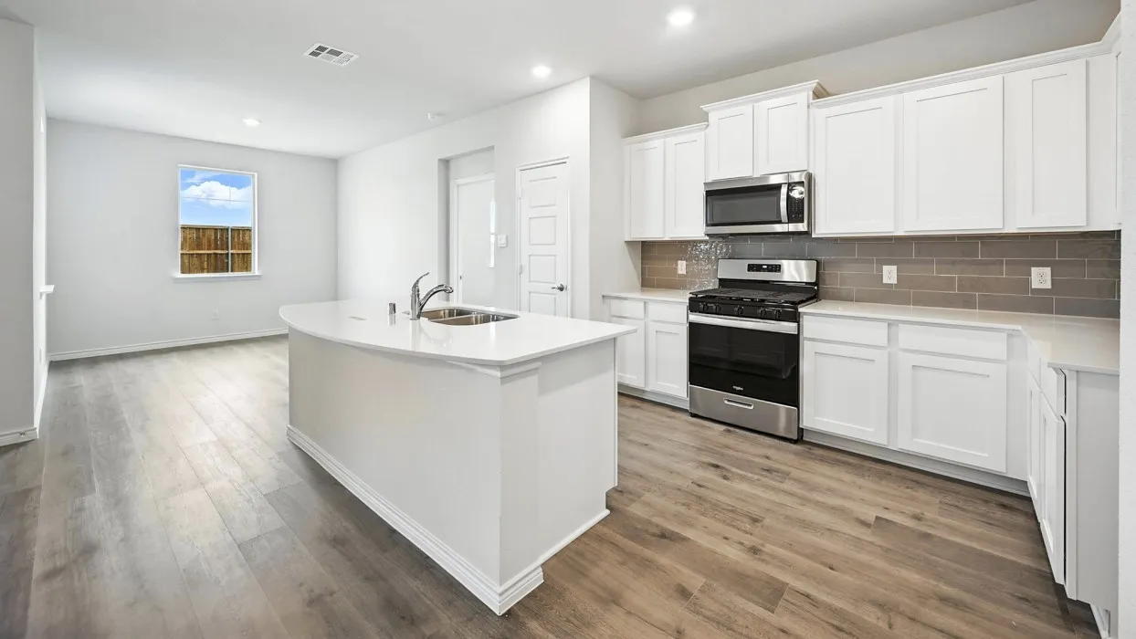 Kitchen featuring wood-finish flooring, white cabinetry, a kitchen island with sink, stainless steel appliances, and a tiled backsplash