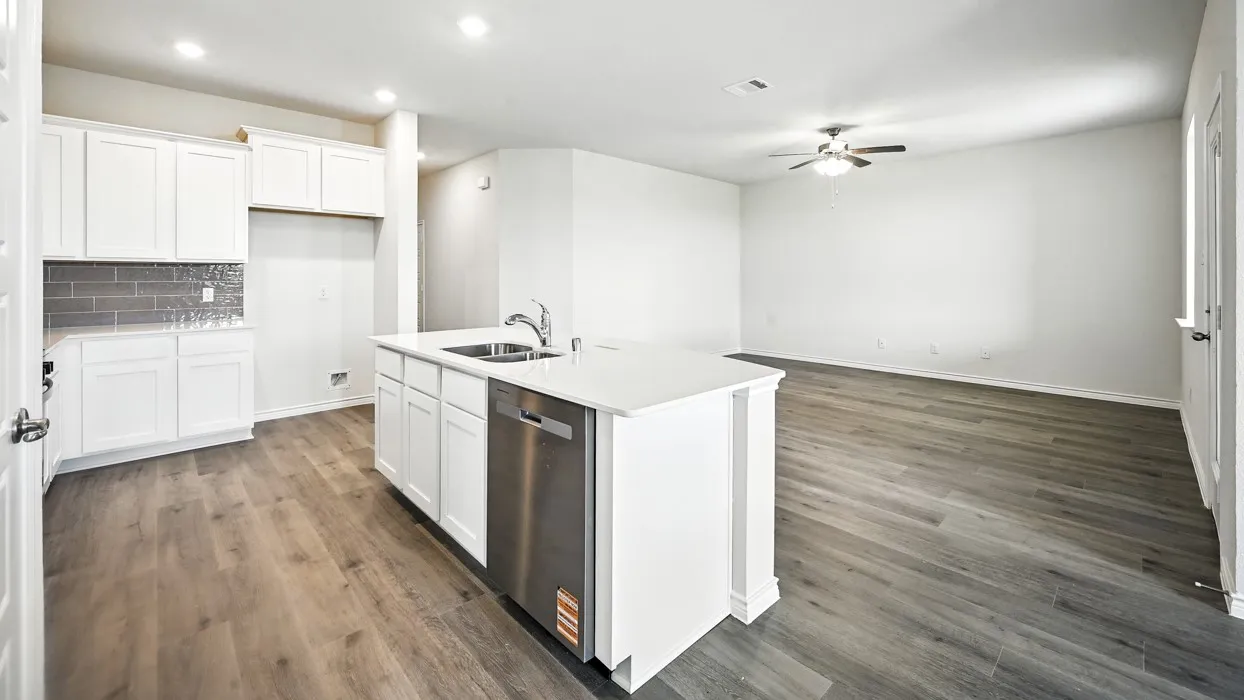 Open-concept living space with wood-finish flooring, recessed lighting, and a ceiling fan