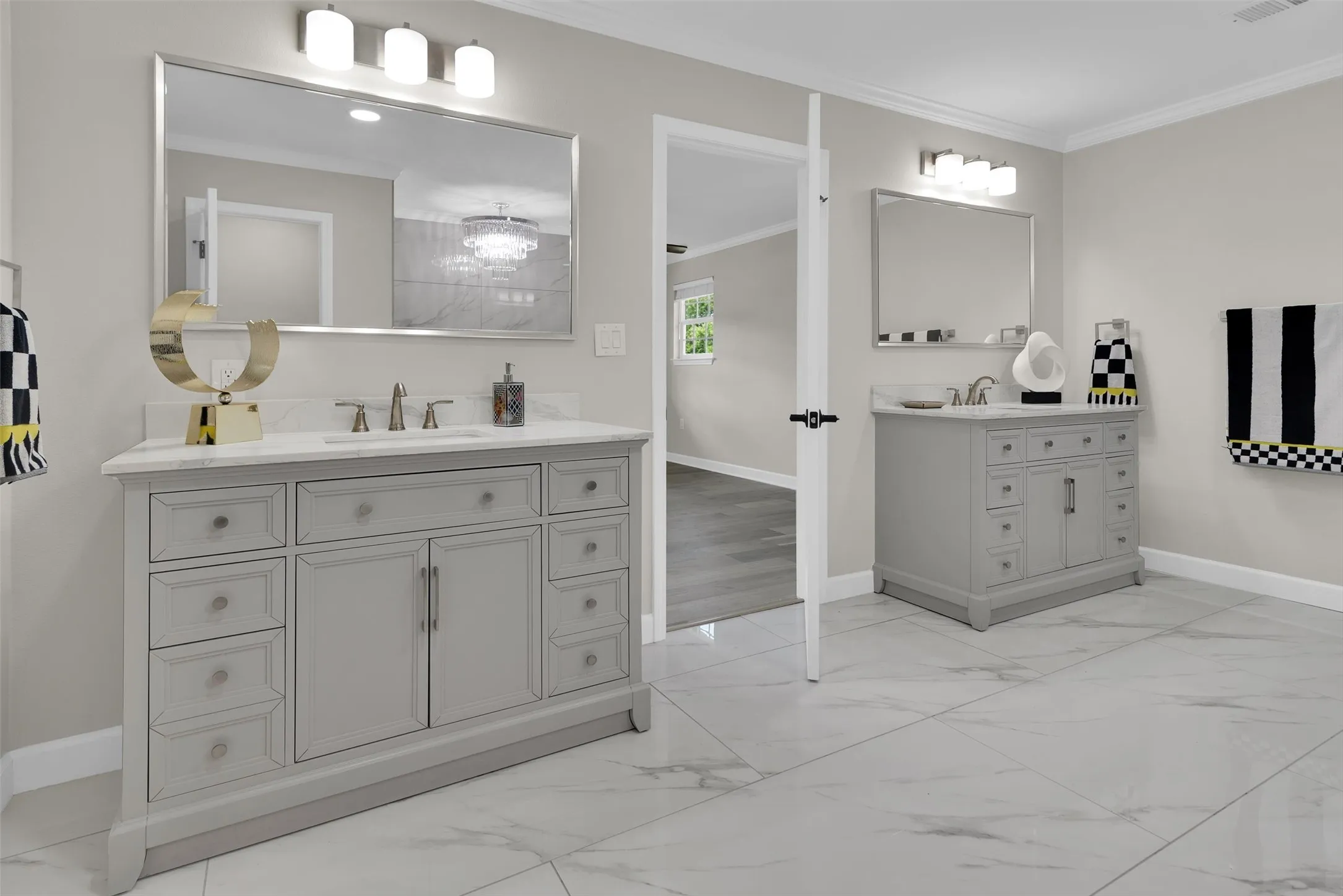 Dual vanity bathroom featuring light gray cabinetry, white countertops, and expansive tile flooring