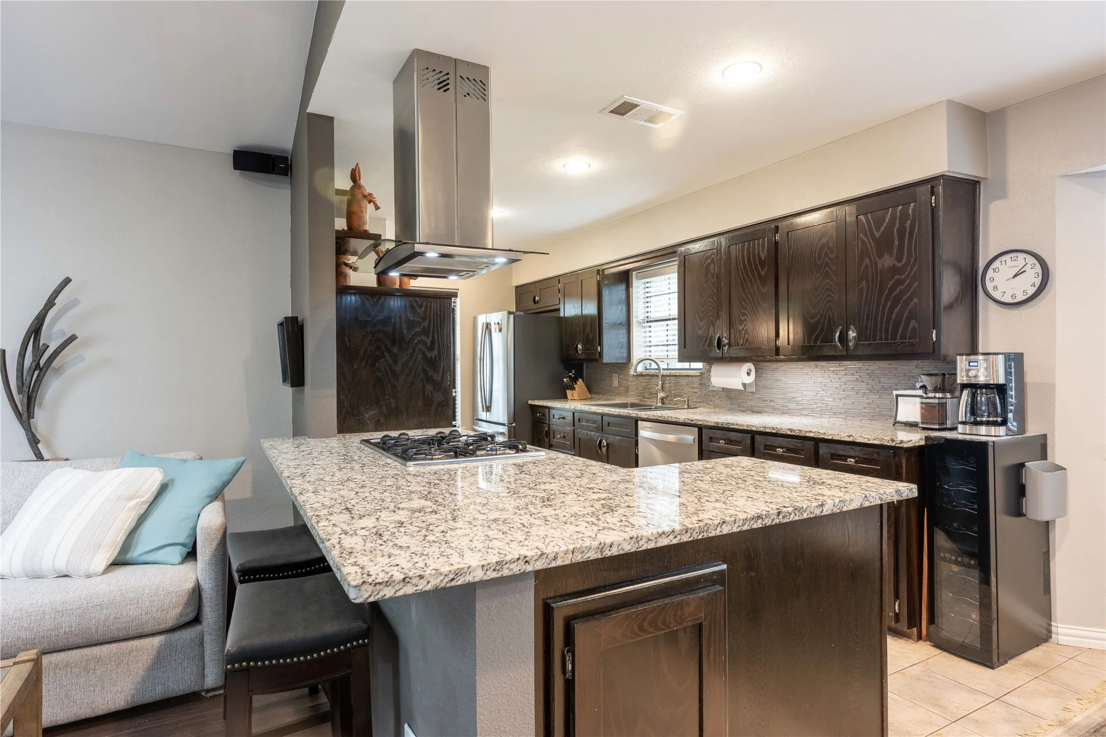 Remodeled open Kitchen with abundant cabinets, granite counter tops & island.