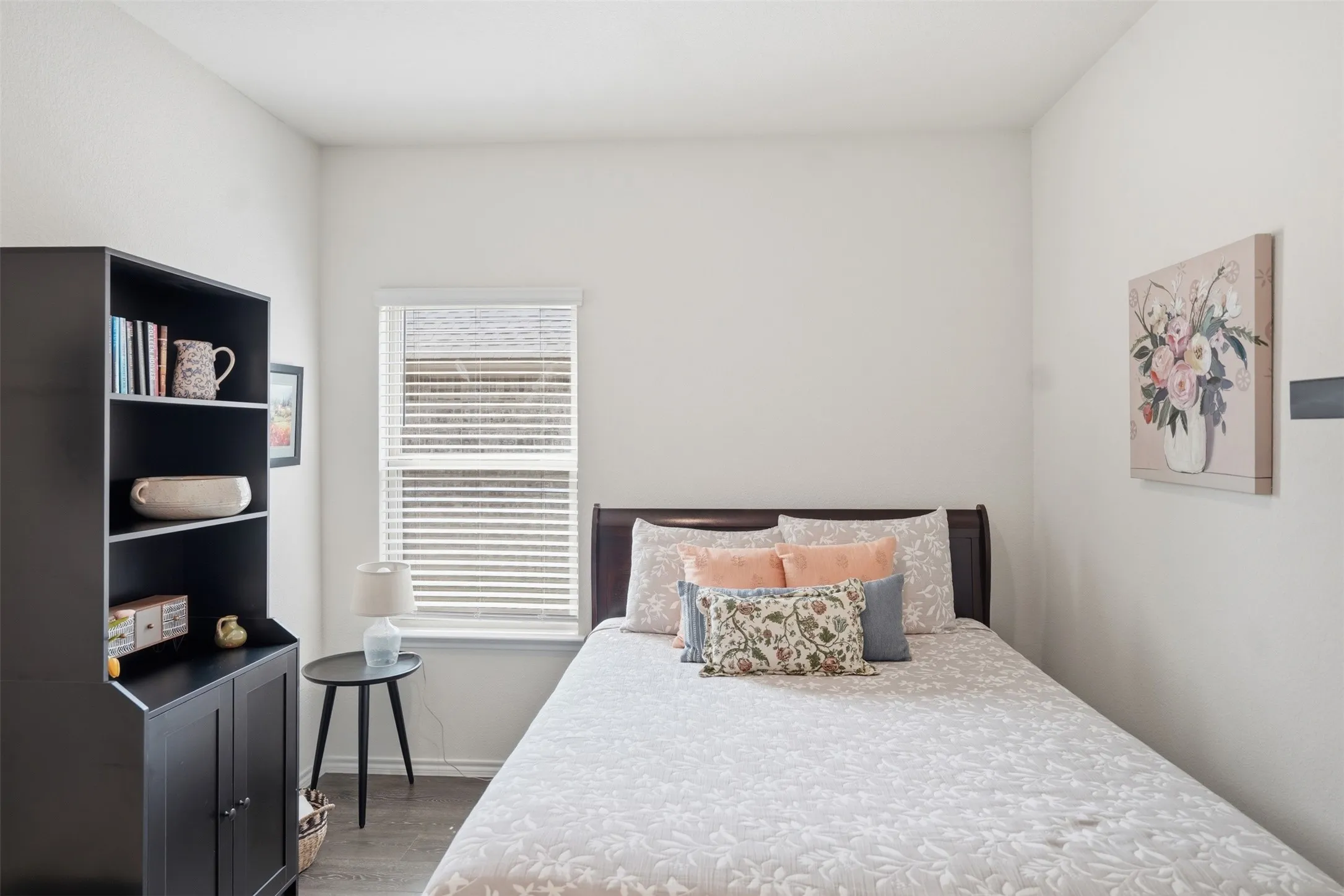 Bedroom 2 - Recessed window with blinds, wood-finish flooring, and white wall finishes