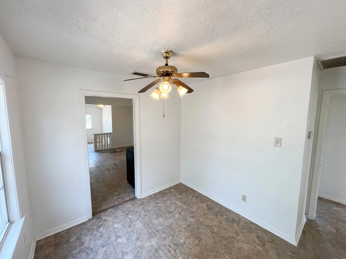Recessed ceiling fan with light fixture, textured ceilings, and patterned vinyl flooring