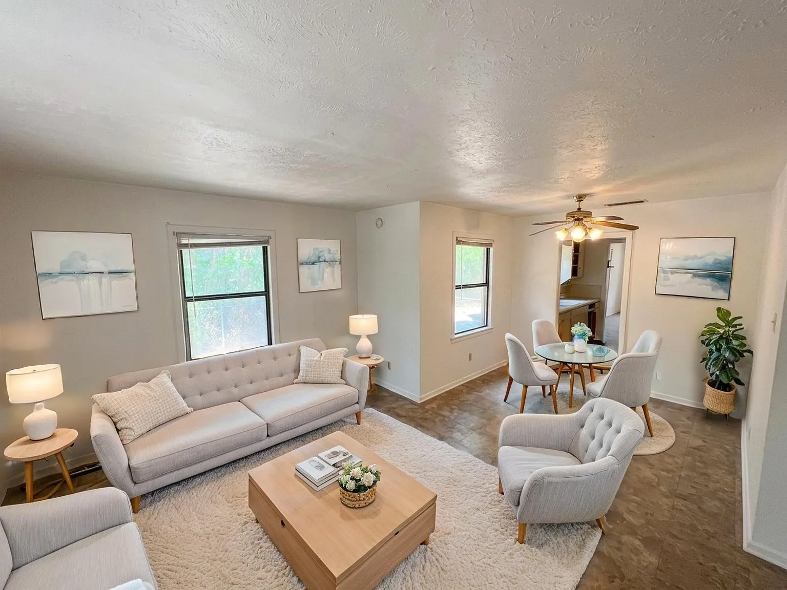 Virtually staged
Open-concept living and dining areas featuring neutral wall tones, multiple windows, and wood-finish flooring