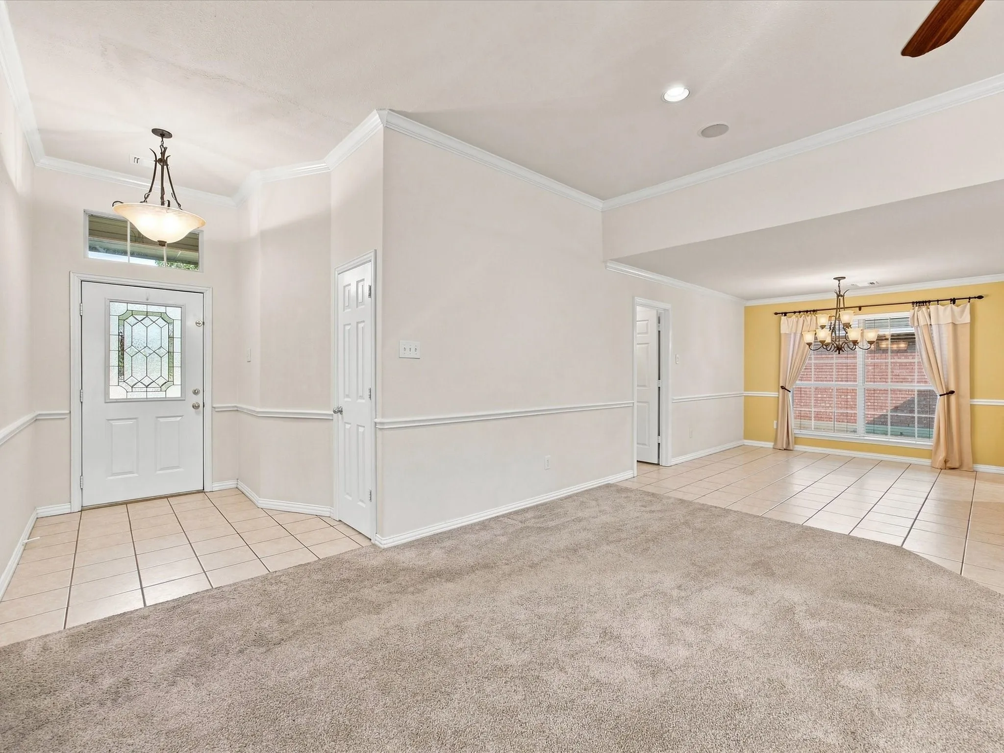 Entry foyer with tiled flooring and a decorative glass door