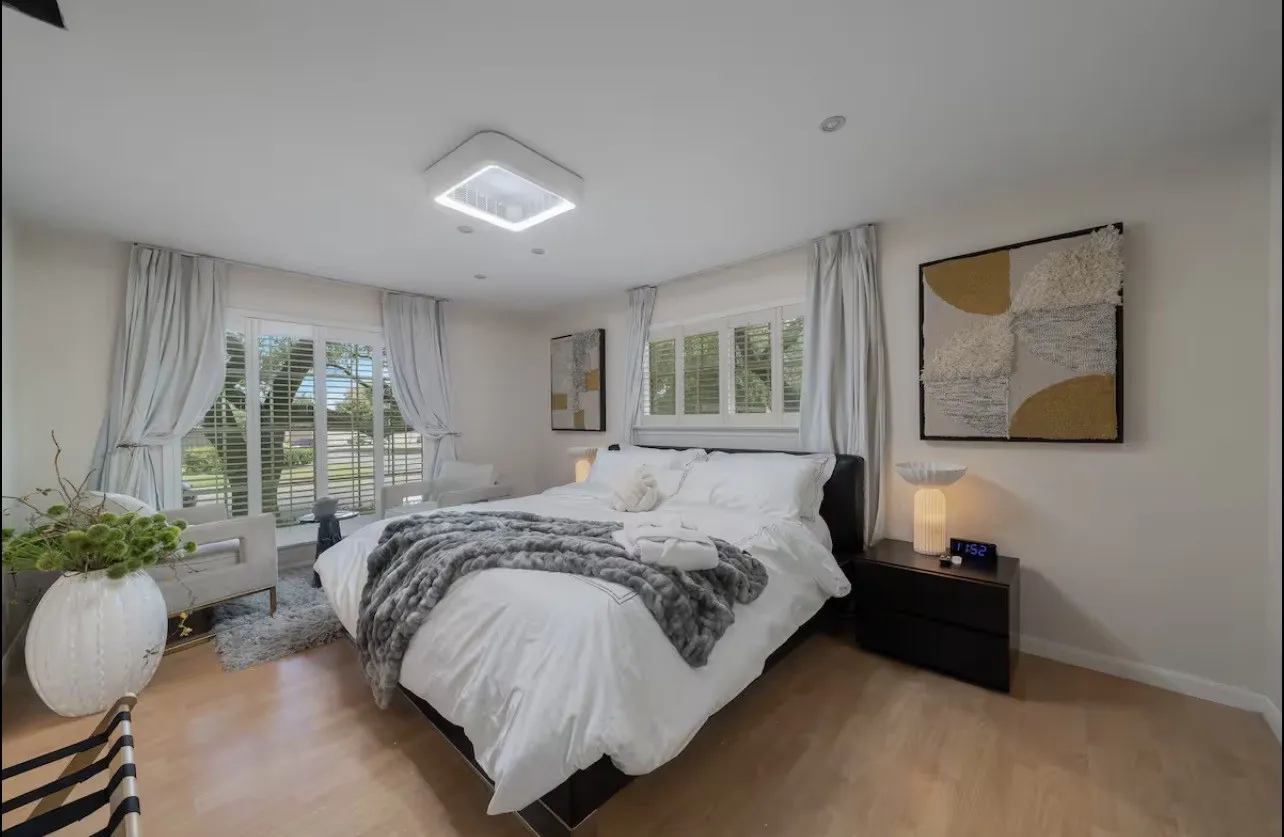 Recessed lighting, wood-finish flooring, and a modern ceiling fixture