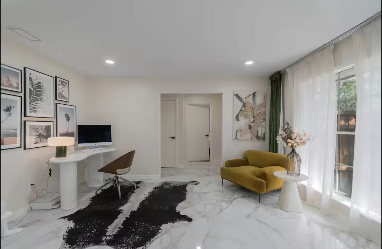 Recessed lighting, light-toned walls, and wood-finish doors with matte black hardware