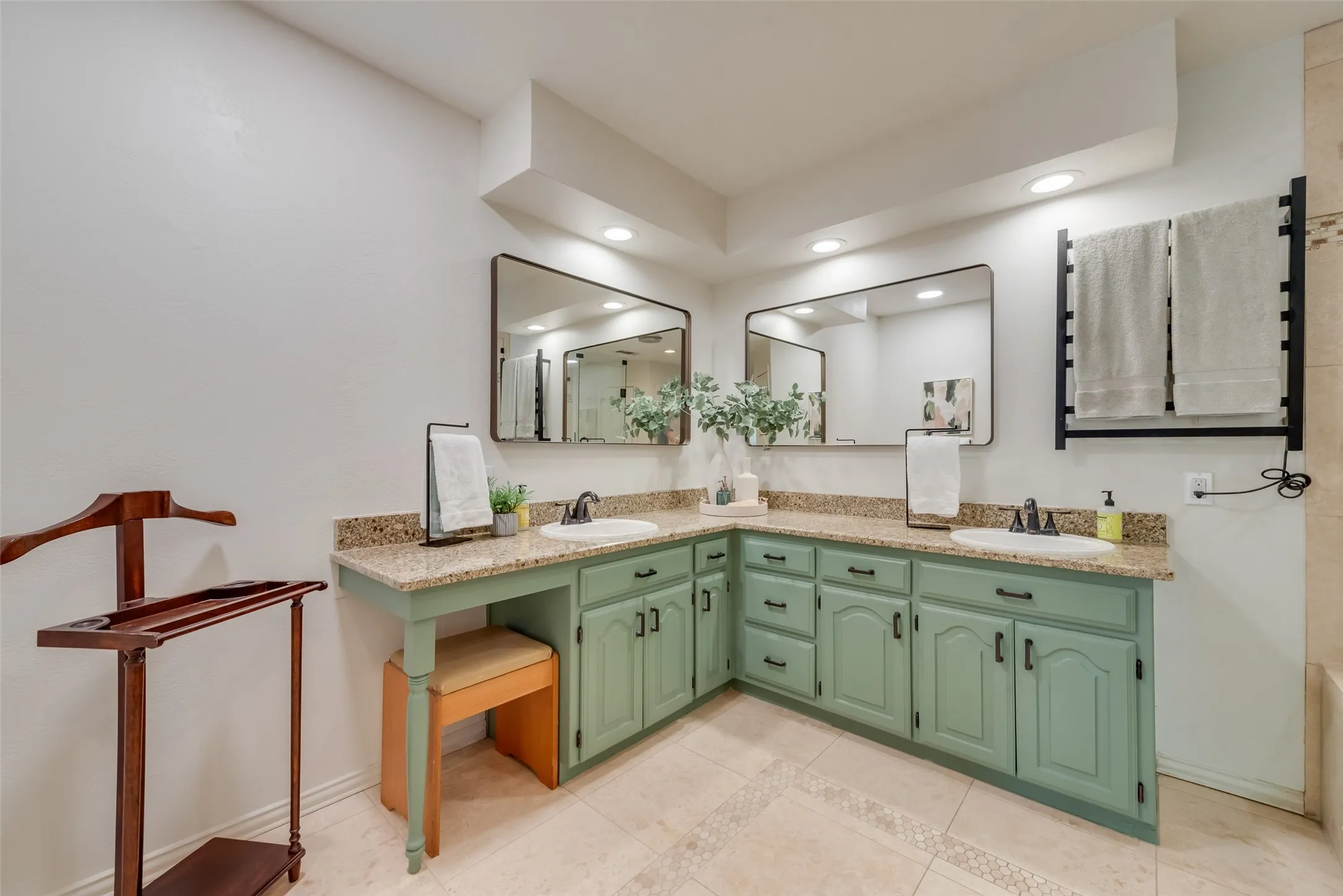 Updated bathroom has dual granite vanities