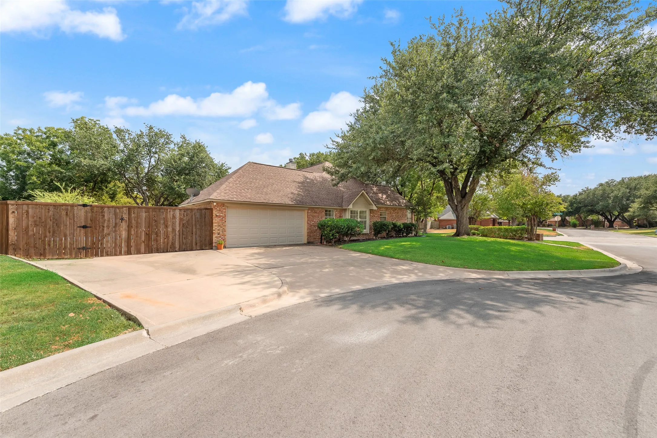 The extended driveway and garage face the cul-de-sac.