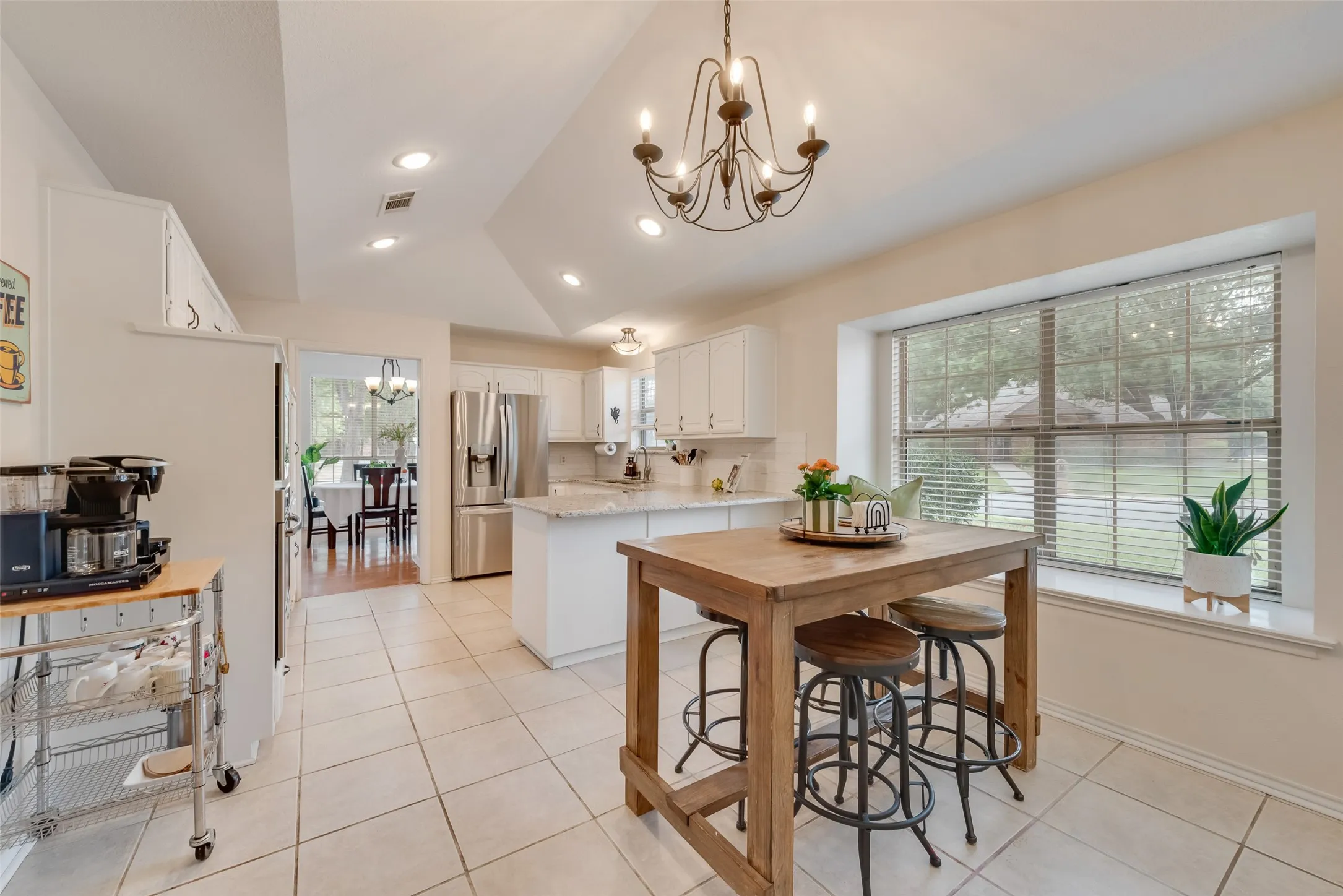 Large window with a window seat and faceted vaulted ceiling make this such a lovely place to sit and enjoy your morning coffee.