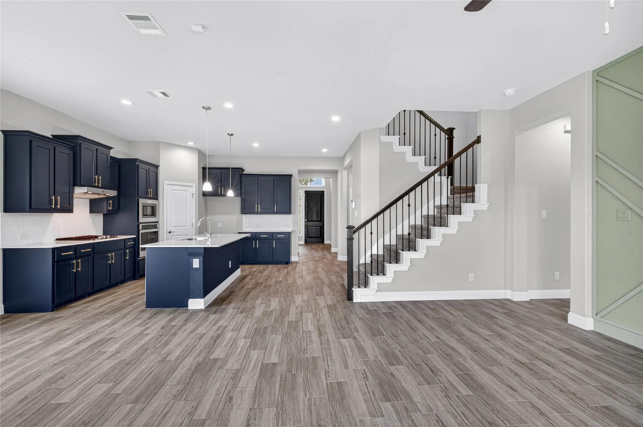 Open-concept living space with wood-finish flooring