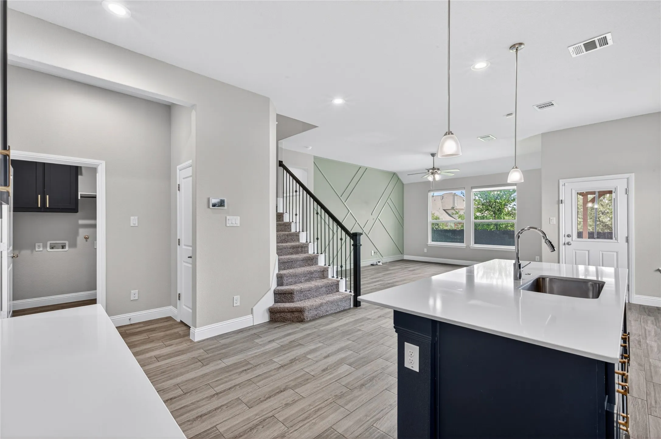 Kitchen island with an undermount sink and pendant lighting